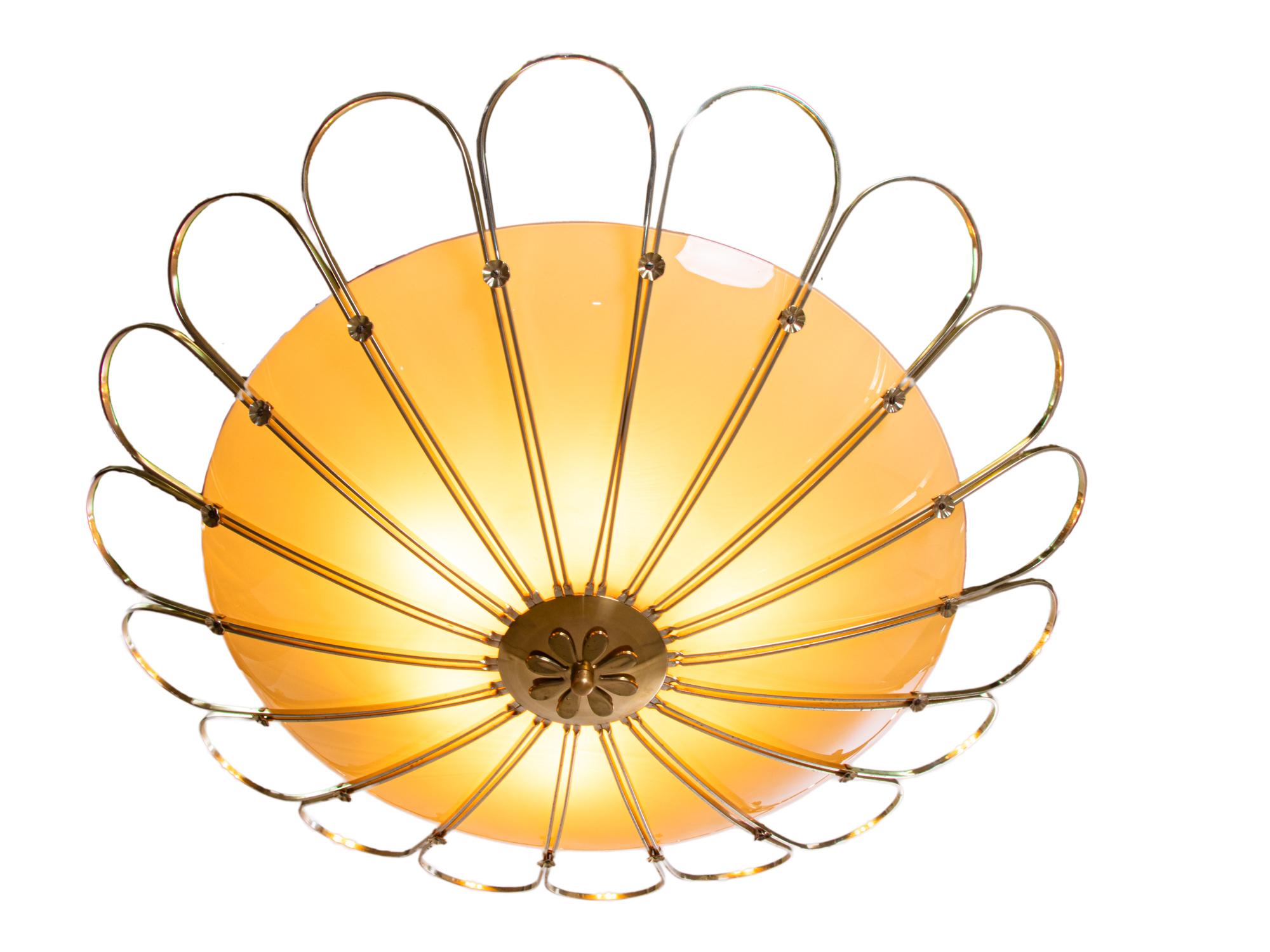 Unique oversized flying saucer semi flush mount lamp with a extra large curved glass shade in a brass petal bowl which holds the six-socket cluster. Chandelier illuminates beautifully and offers a lot of light. Gem of the time. 
 
Manufactured by