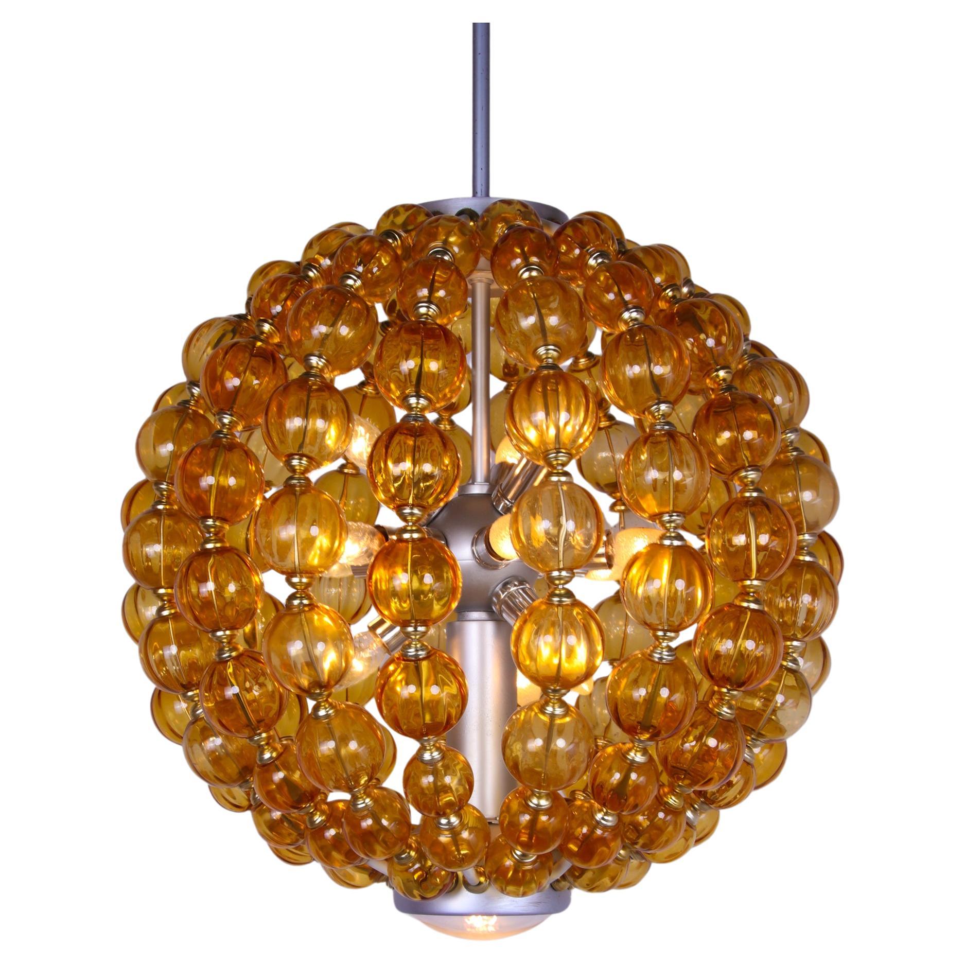 Spectacular huge 13 lights ballroom chandelier by VEB Leuchtenbau Leipzig, Germany with hand blown amber glass balls on a metal frame. 

This Impressive chandelier was made in Eastern Germany in the 1960s. 
It’s a highly distinctive piece and looks