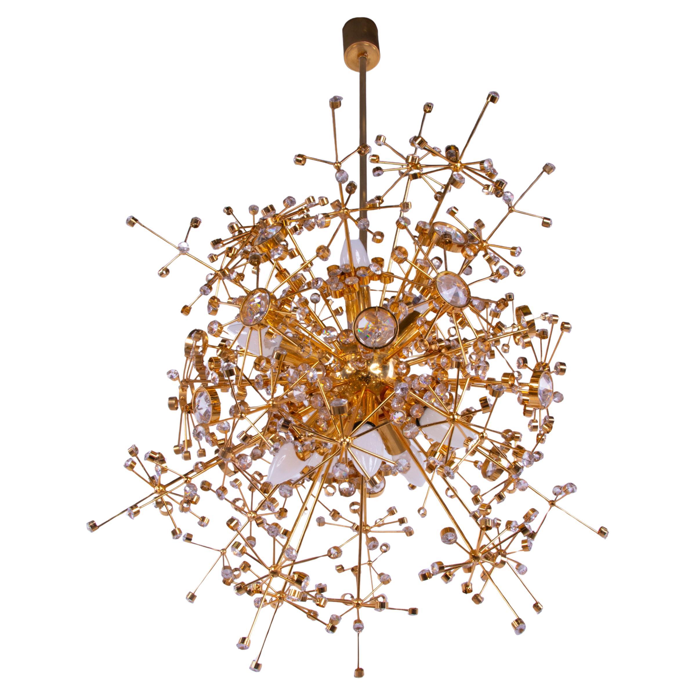 Outstanding mid century Sputnik chandelier made of a gilt brass construction with Swarovski crystals. Designed by Christoph Palme. Chandelier illuminates beautifully and offers a lot of light. Gem from the time. With this light you make a clear