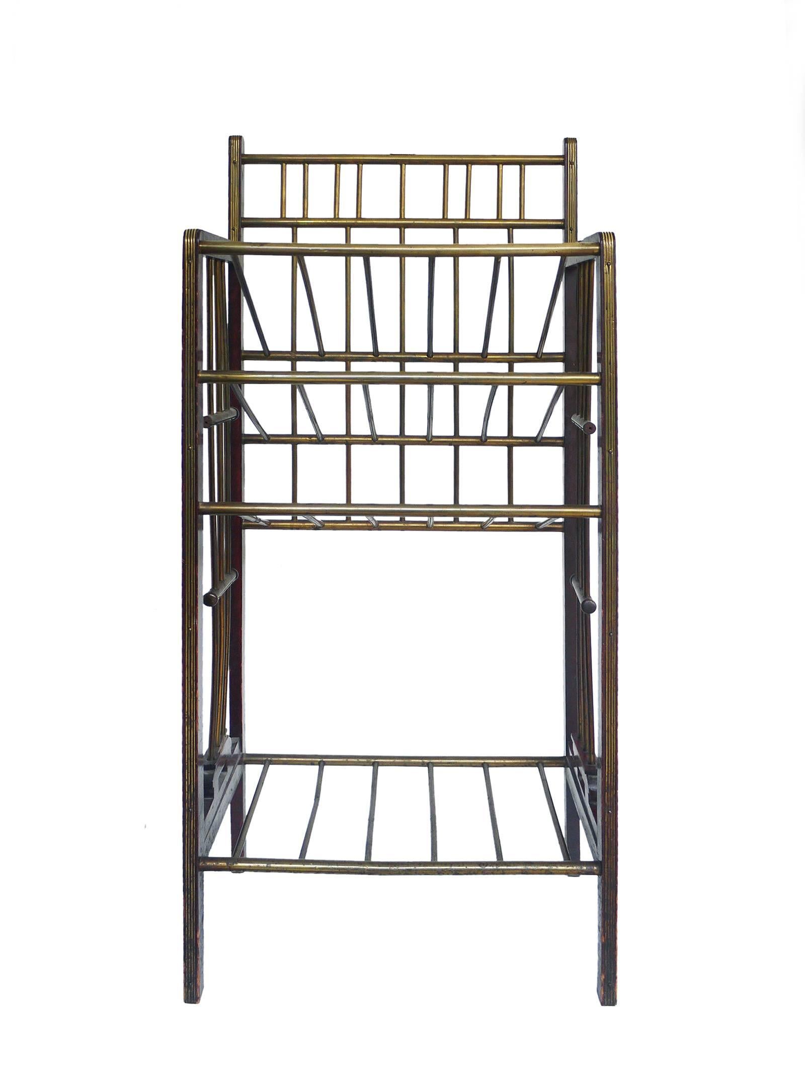 Magazine stand made of brass and mahogany from the period of the Vienna Secession, circa 1900. 

A beautiful piece in the manner of Koloman Moser and Josef Hoffmann.
The metal label (gesetzlich geschützt) used in Austria and Germany to note