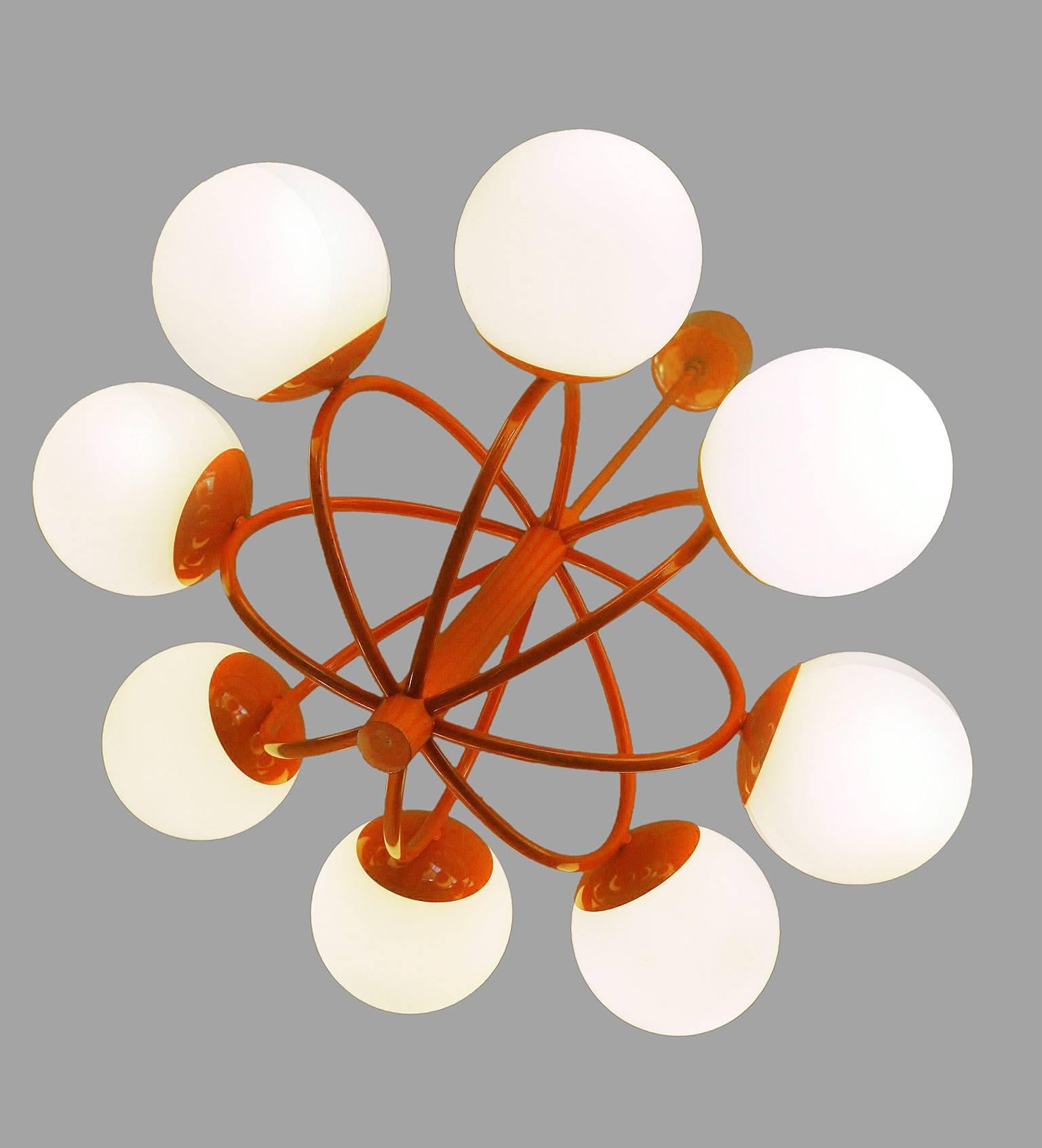 Kaiser atomic chandelier with eight white opal glass balls on an orange metal frame, made in Germany in the 1960s. Very good to excellent condition with all original components. European wiring with fabric cable.