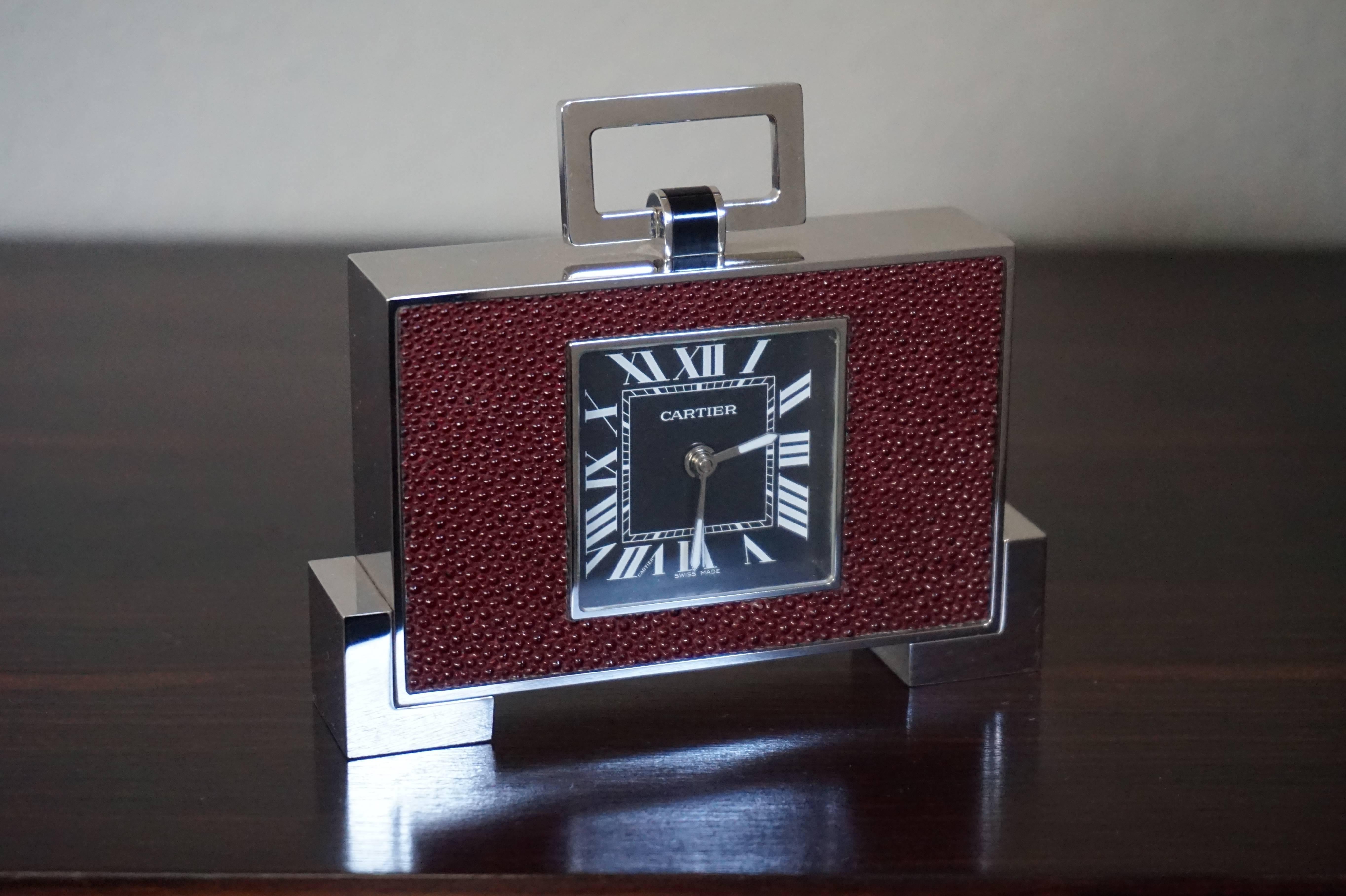 Stunning design and top quality, Swiss made traveling clock by Cartier.

This Art Deco style traveling clock is by one the world's most famous and best quality makers. The design and the look and feel just make you happy and when you feel the