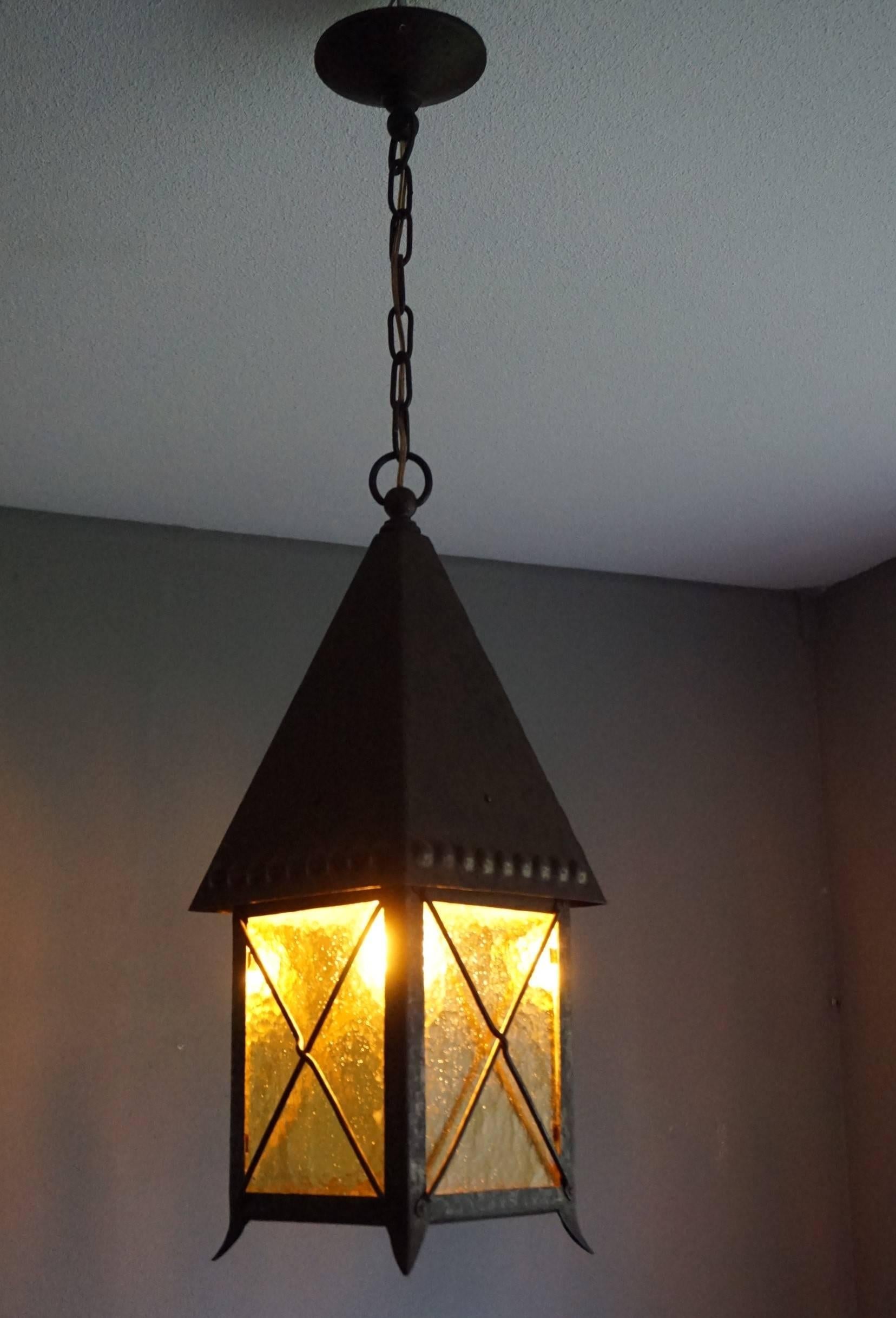 One of a kind, hand-crafted pendant with original amber color glass.

If you live in an early 20th century house or appartment then this practical size and all hand-crafted, wrought iron pendant could be perfect for you. This fine example was made