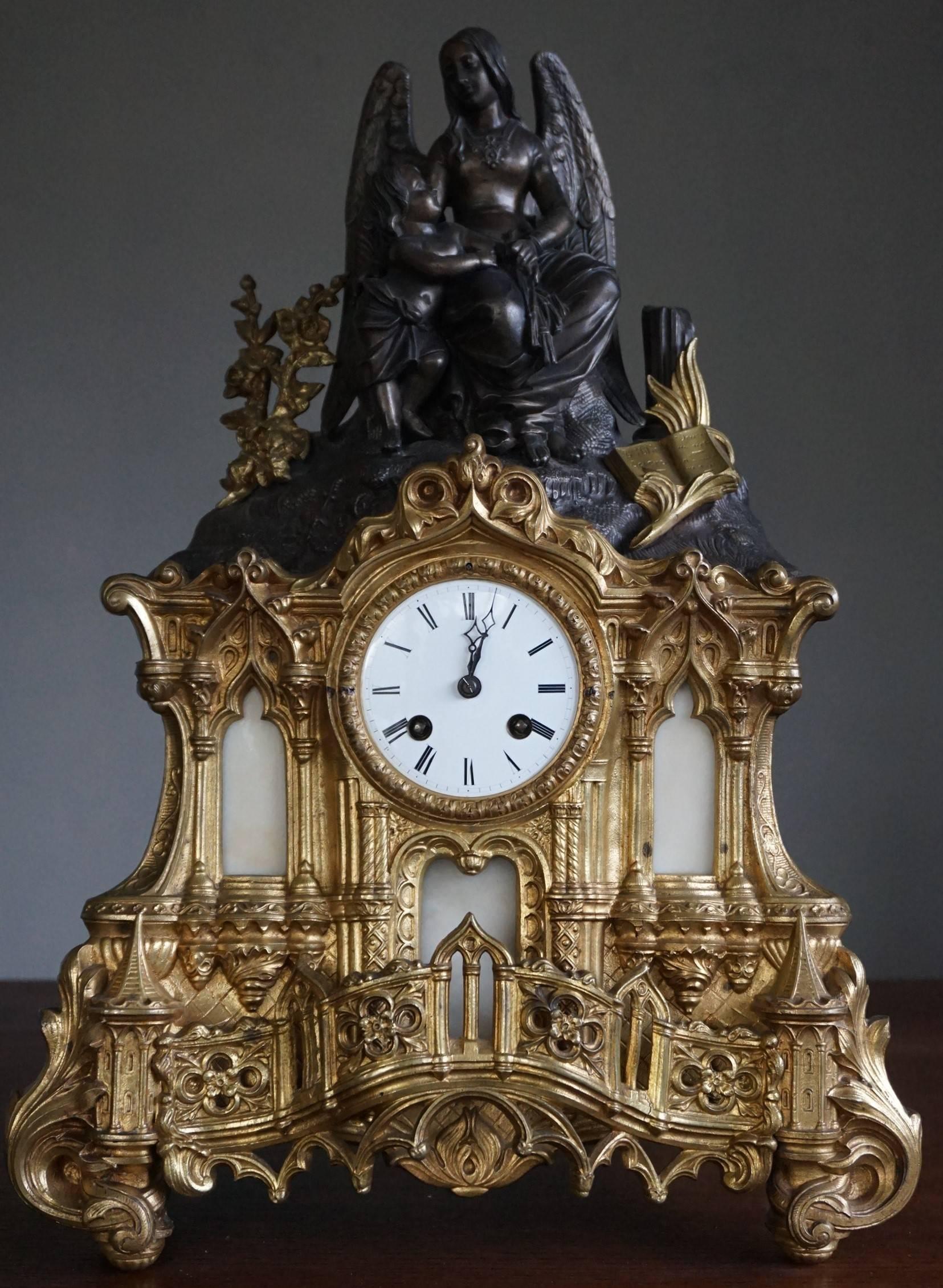 Cathedral design, gilt bronze and zinc clock.

This sizable, handcrafted, gracious and meaningful clock comes with a variety of Gothic church elements. As a matter of fact, the bottom half of this mantle clock very much resembles the entrance of a