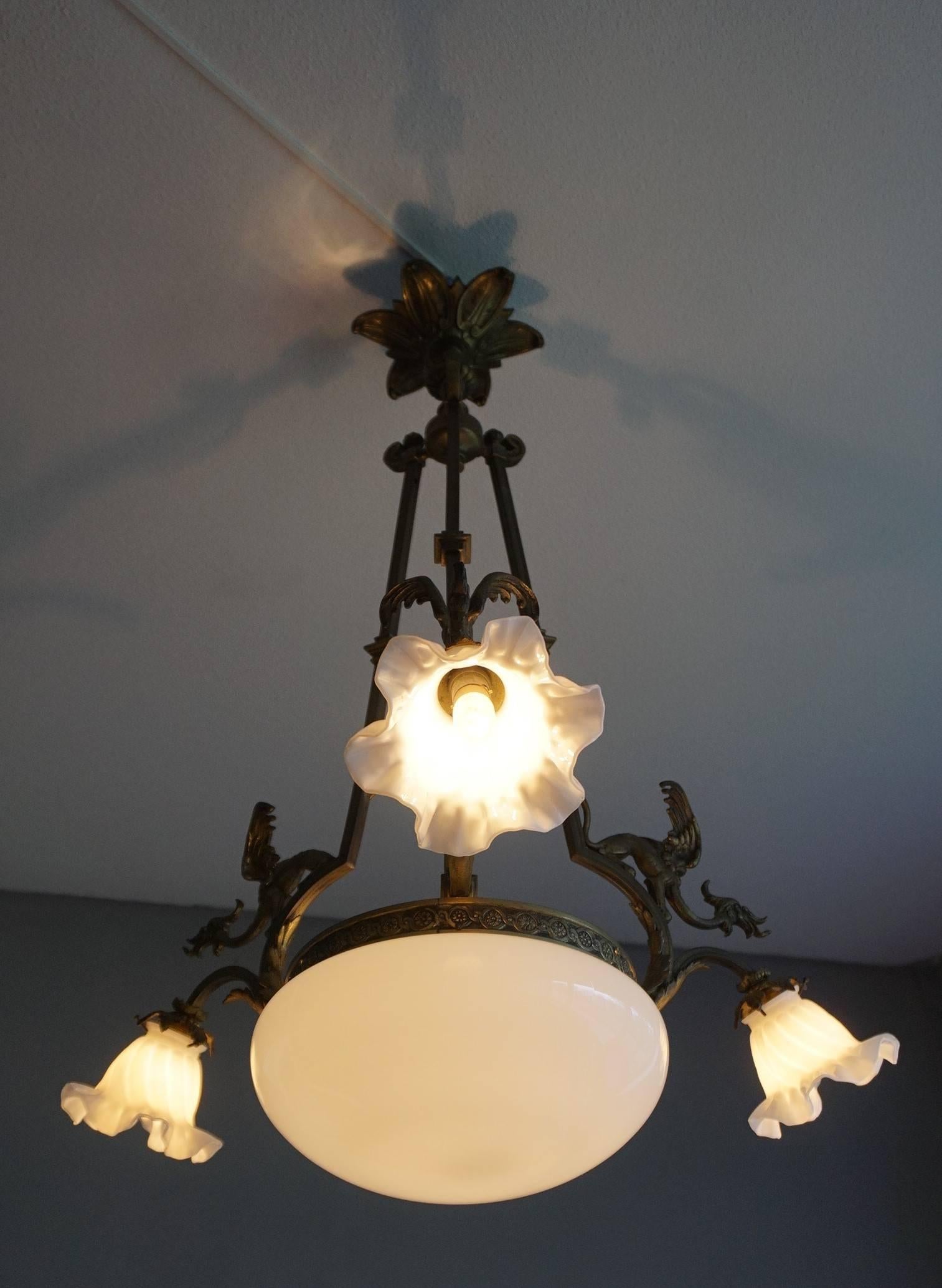 Handcrafted, turn of the century work of lighting art.

If you are looking for a practical size, quality made and perfect condition chandelier to grace your living space then this Gothic Revival light fixture could be perfect for you. It is not only