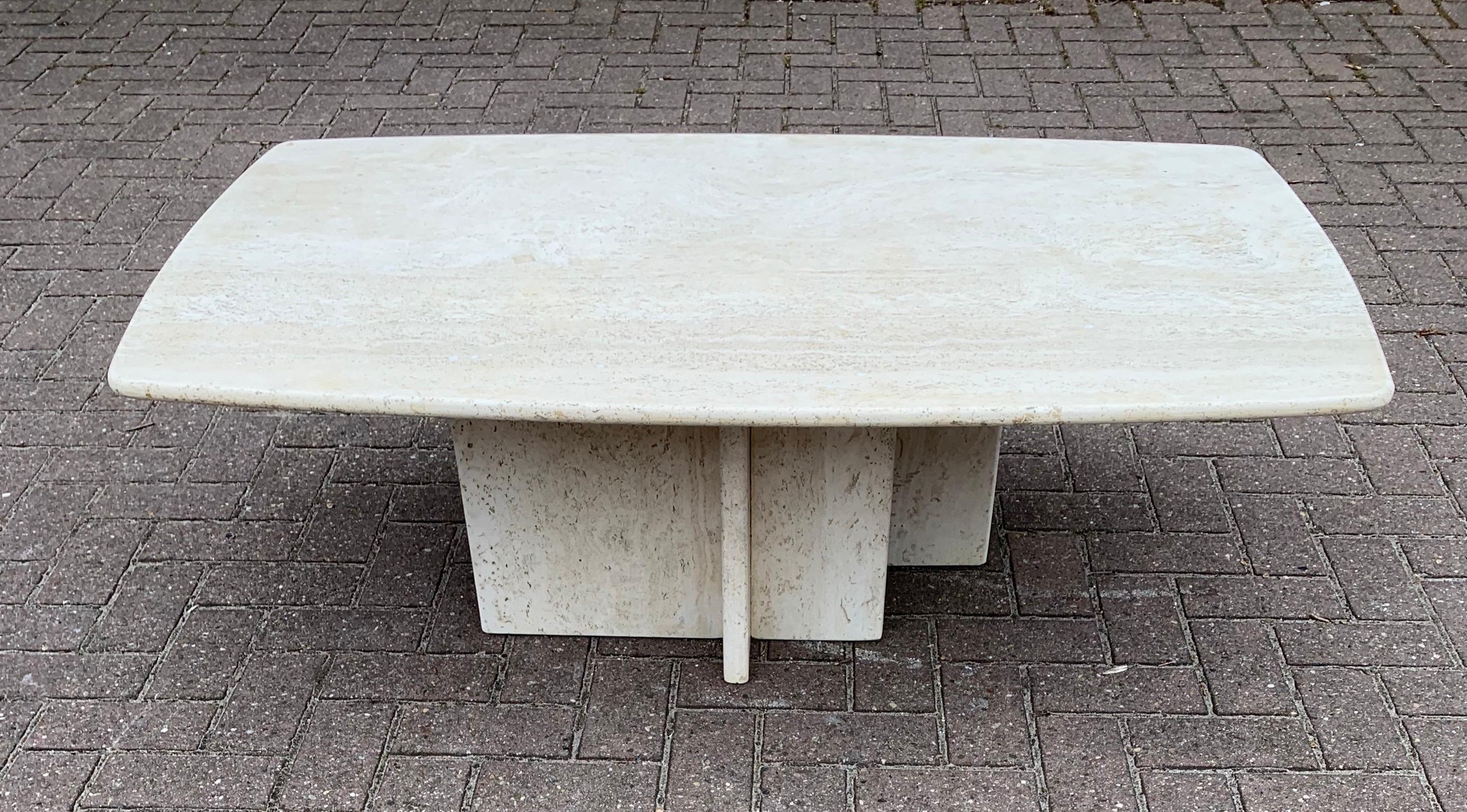 Stylish and functional Italian, hardstone table. 

This large size travertine table with rounded sides and an attractive, asymmetrical base is in good to excellent condition. Because of the timeless design this hardstone table can be used in all