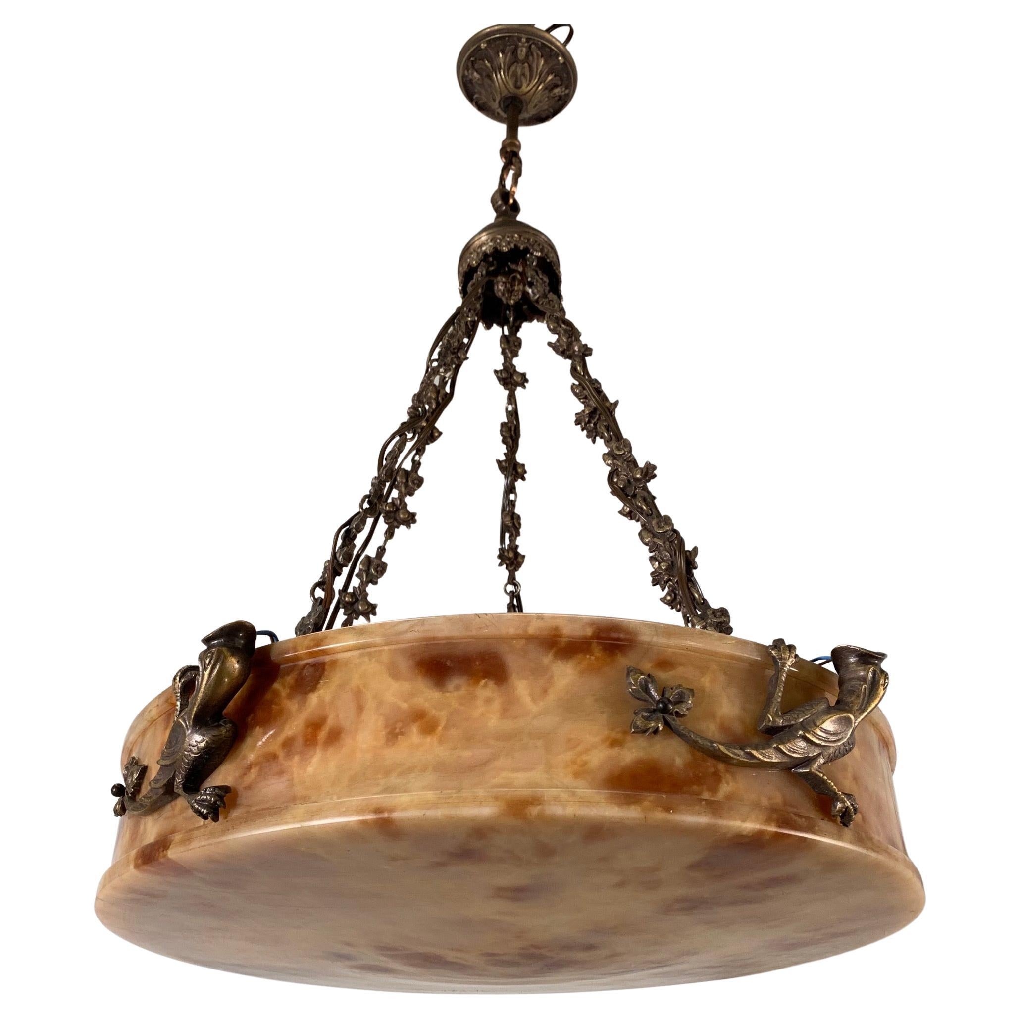 Beautiful design and wonderful light creating, mineral stone fixture.

This marvelous, early 20th century alabaster and bronze work of lighting art is another one of our recent and great finds. This rare, possibly unique and definitely large Art