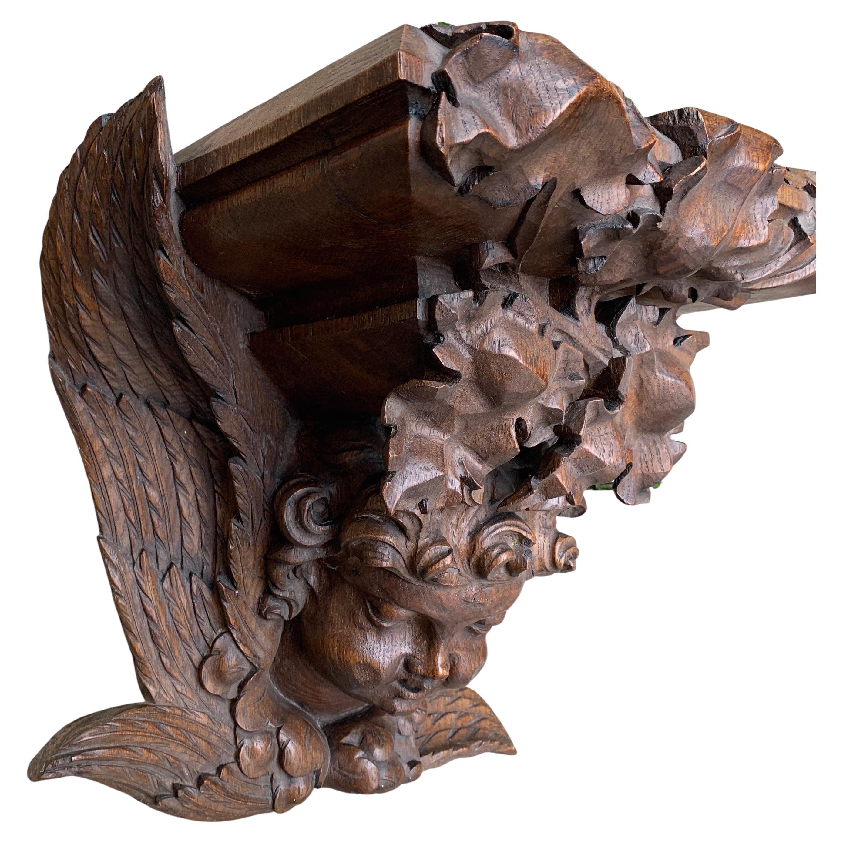 Amazingly hand carved church wall bracket with a winged angel sculpture.

This stunning and all handcrafted, Gothic Revival wall bracket has the most wonderful shape and patina. The overall design with the natural flowing and deeply carved leafs