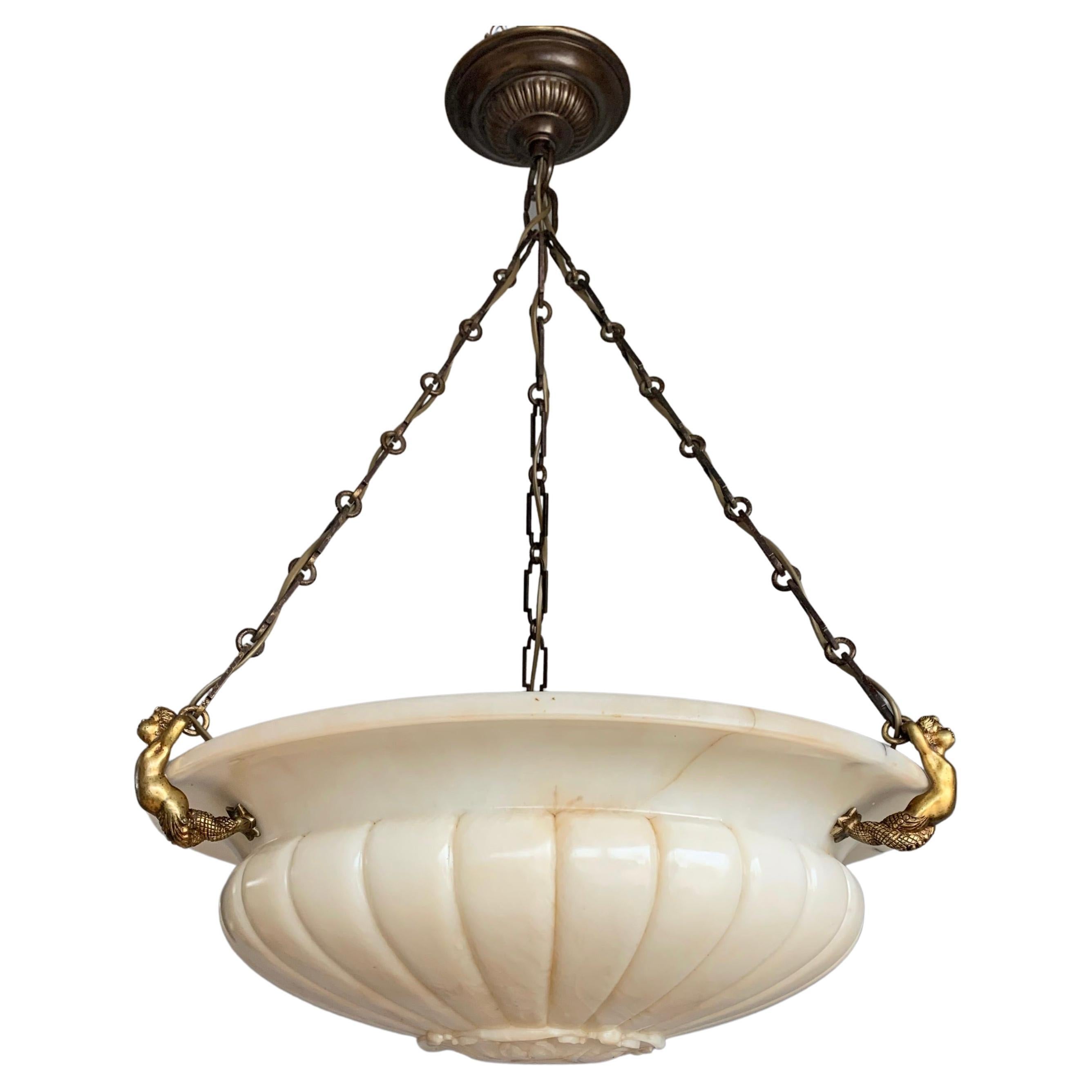 Stunning and one of a kind antique characteristic chandelier from the early 1900s.

This great looking and large Italian Neo Classical Style alabaster mineral stone chandelier will light up your day every time you look at it. The deeply carved lines