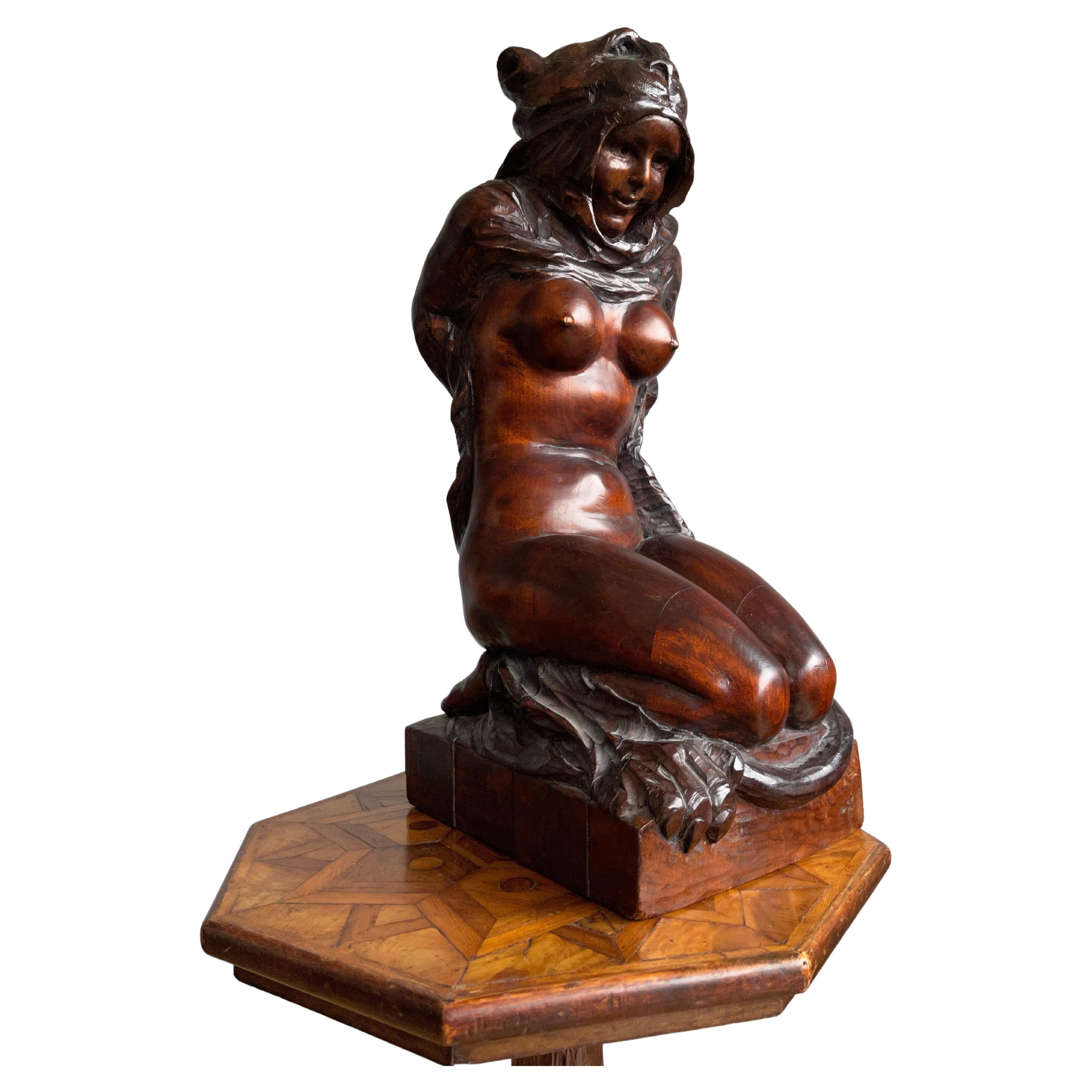 Rare early 20th century sculpture. 

This beautifully carved female Amazon has a wonderful patina and the lifelike pose and shape make it even more impressive. The skin of the hunted 'big cat' is draped around her naked body like a dress and she