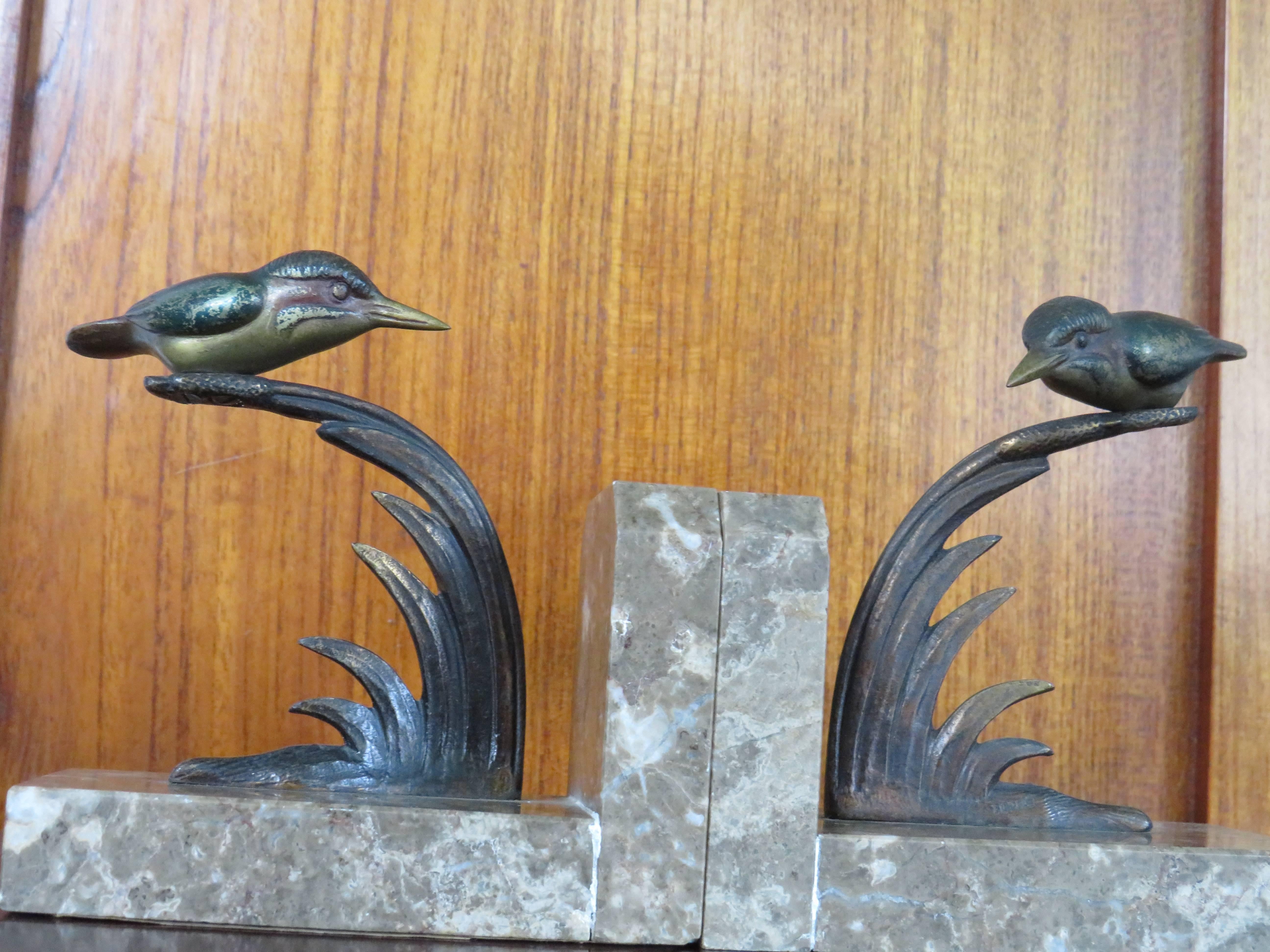 Unique on 1stdibs and possibly worldwide.

This small pair of stylish bookends from circa 1925 is an absolute joy to watch. Both these bookends have the word 'bronze' cast at the bottom of the reeds (see image 3). The kingfisher on the left is