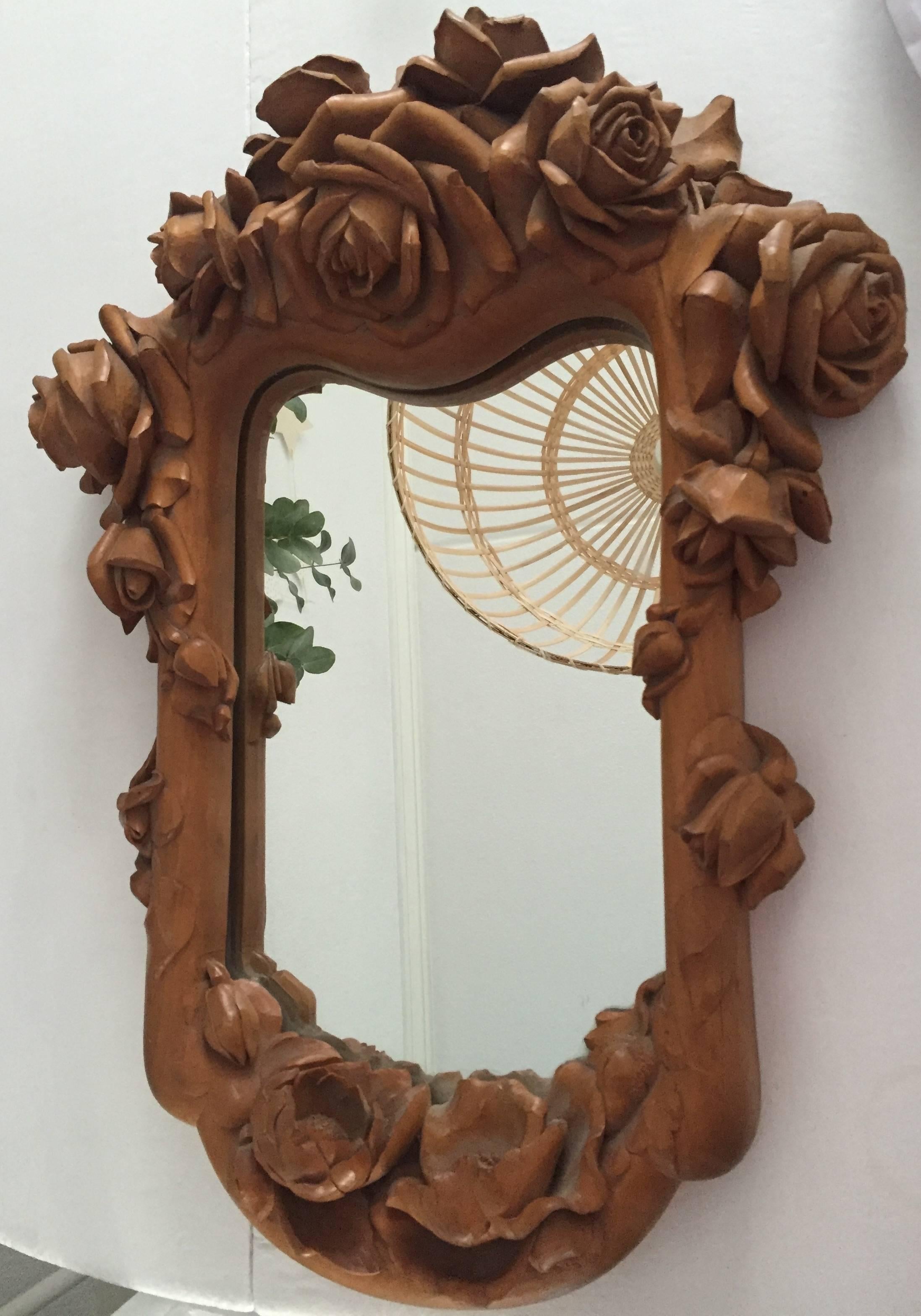 Top quality artistic and decorative mirror.

This magnificent wall mirror is carved out of one piece of wood. The abundance of blooming rozes is a joy to watch and the artist proudly (and rightly so) signed this work of art Jef. Deconinck, 1966. We