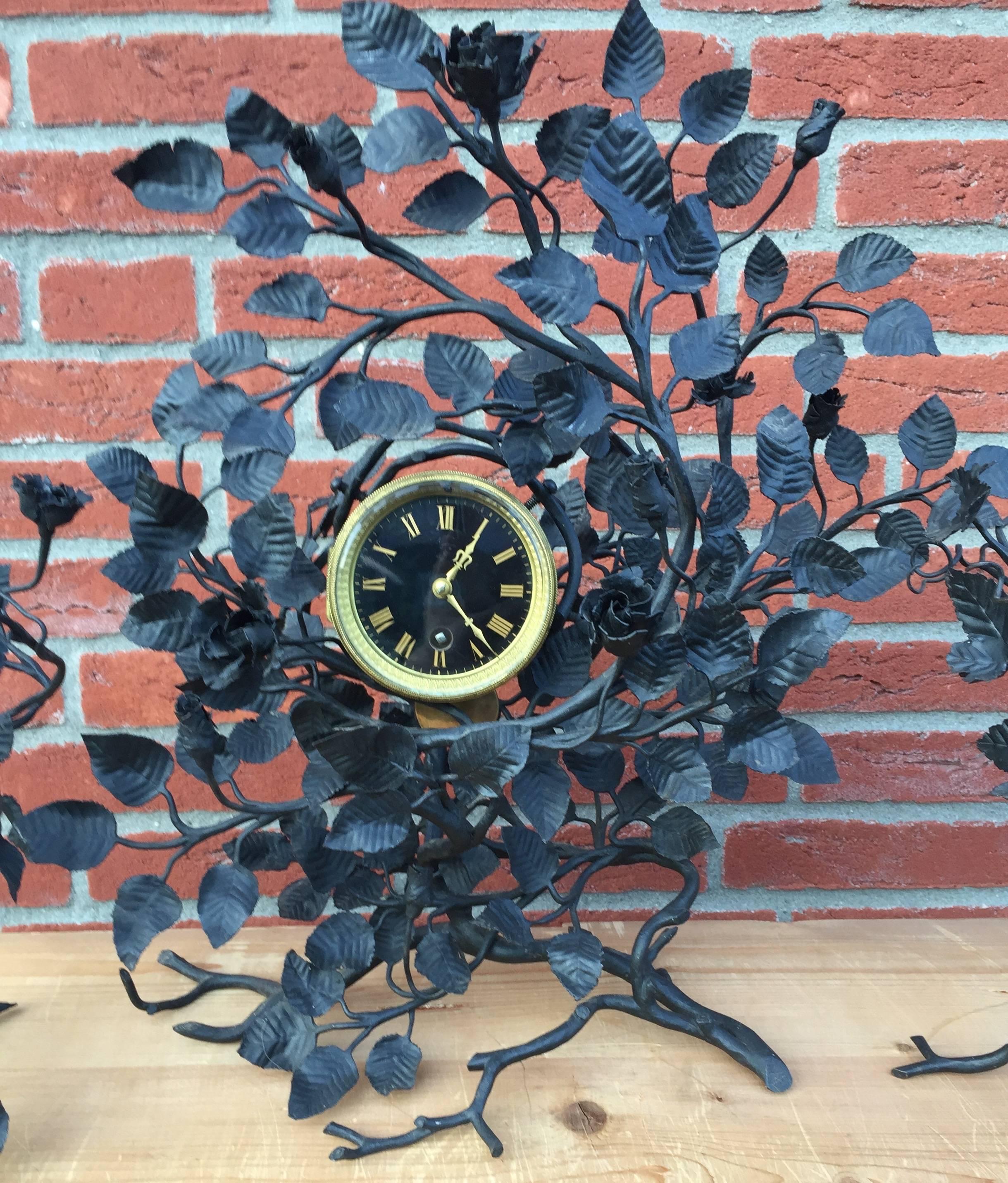 Remarkable and highly decorative handmade clock garniture marked AE.

This antique French clock comes with two matching candle holders. This is a rare set and the clock has a good working 8 day mechanism. It must have taken a black- or silversmith