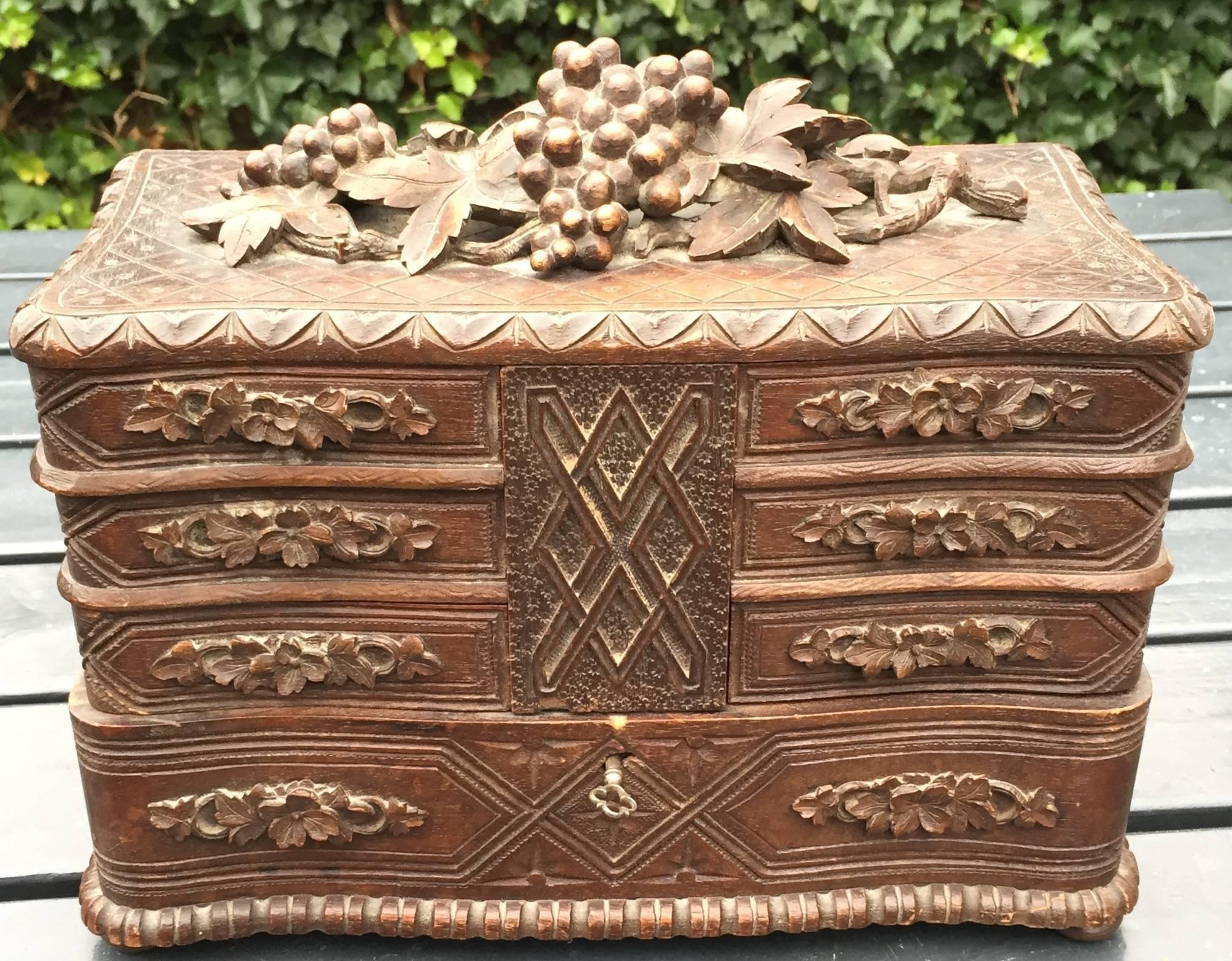 A beautiful antique black forest Jewelry box with fine interior.

This rare and large jewelry box makes a beautiful accessory for a lady with an eye for fine arts. It is a very well carved gem and highly practical with many drawers and a good