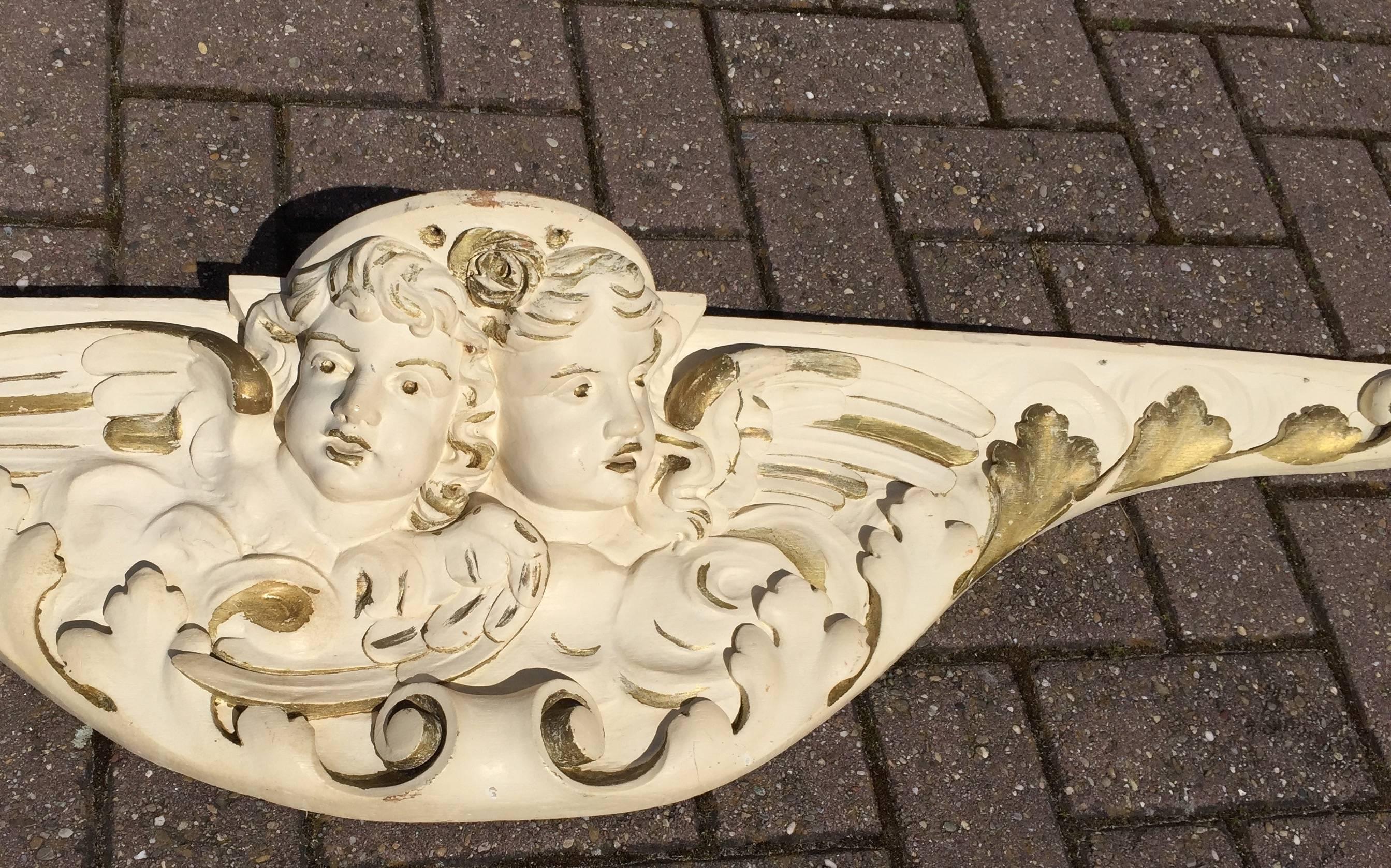 Large and lovely 19th century figural wall bracket

This angelic wall bracket is a great decorator's piece. It is entirely sculpted by hand and out of solid oak. It is painted in beige and gold color and the winged angels look down from the sky.