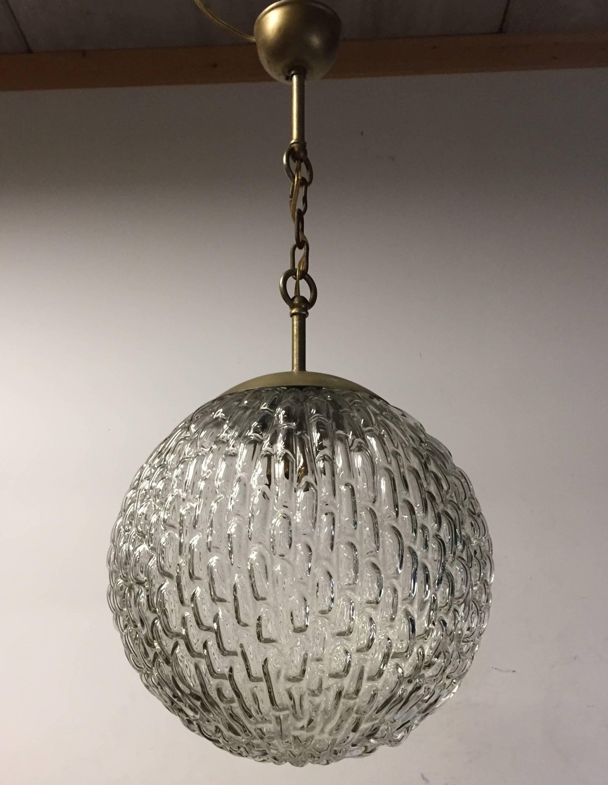 Practical size and handblown ceiling lamp with relief on the surface, probably by Glashütte Limburg. 

This mid-20th century glass pendant comes with the original chain and ceiling cap. The organic natural design of this pendant is a joy to watch