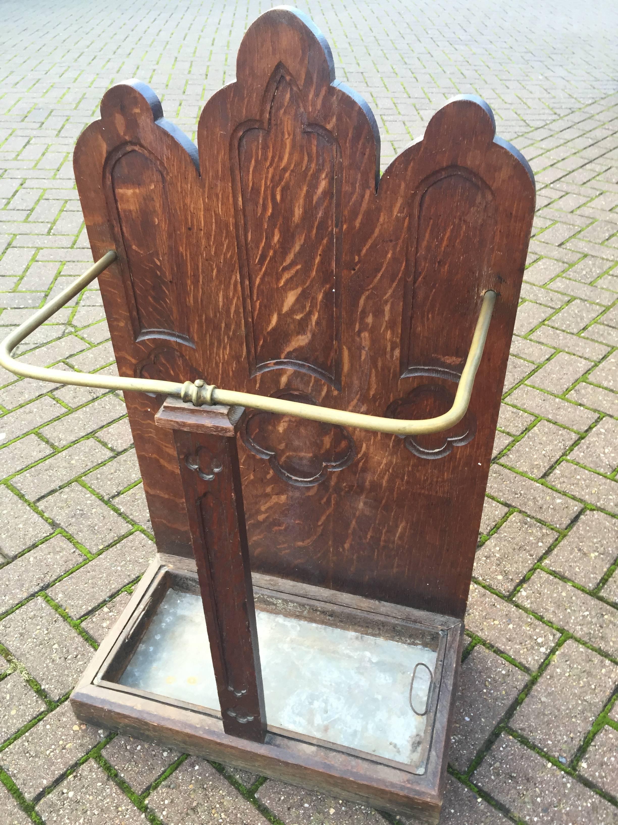 Turn of the Century Gothic Revival umbrella or stick stand.

This antique and rare, Gothic Revival umbrella stand has beautiful Gothic elements in the stunning, tiger oak panels. It is complete with the original zinc bottom and it will look great in