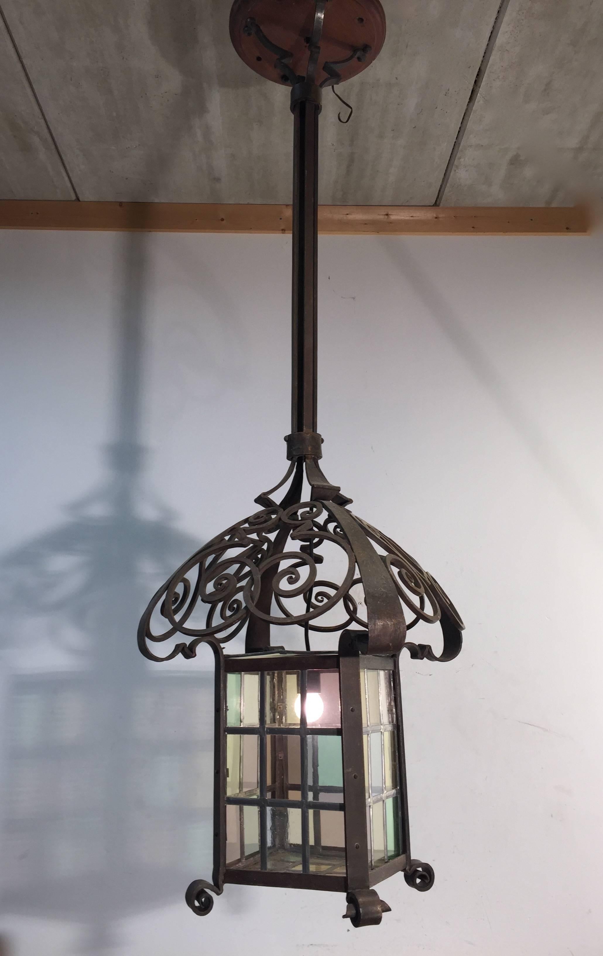 Stunning and huge wrought iron pendant with stained glass. 

This beautiful and organic design pendant is in excellent and good working condition. If you are a lover of the Jugendstil and Art Nouveau period and you have room for this enormous and