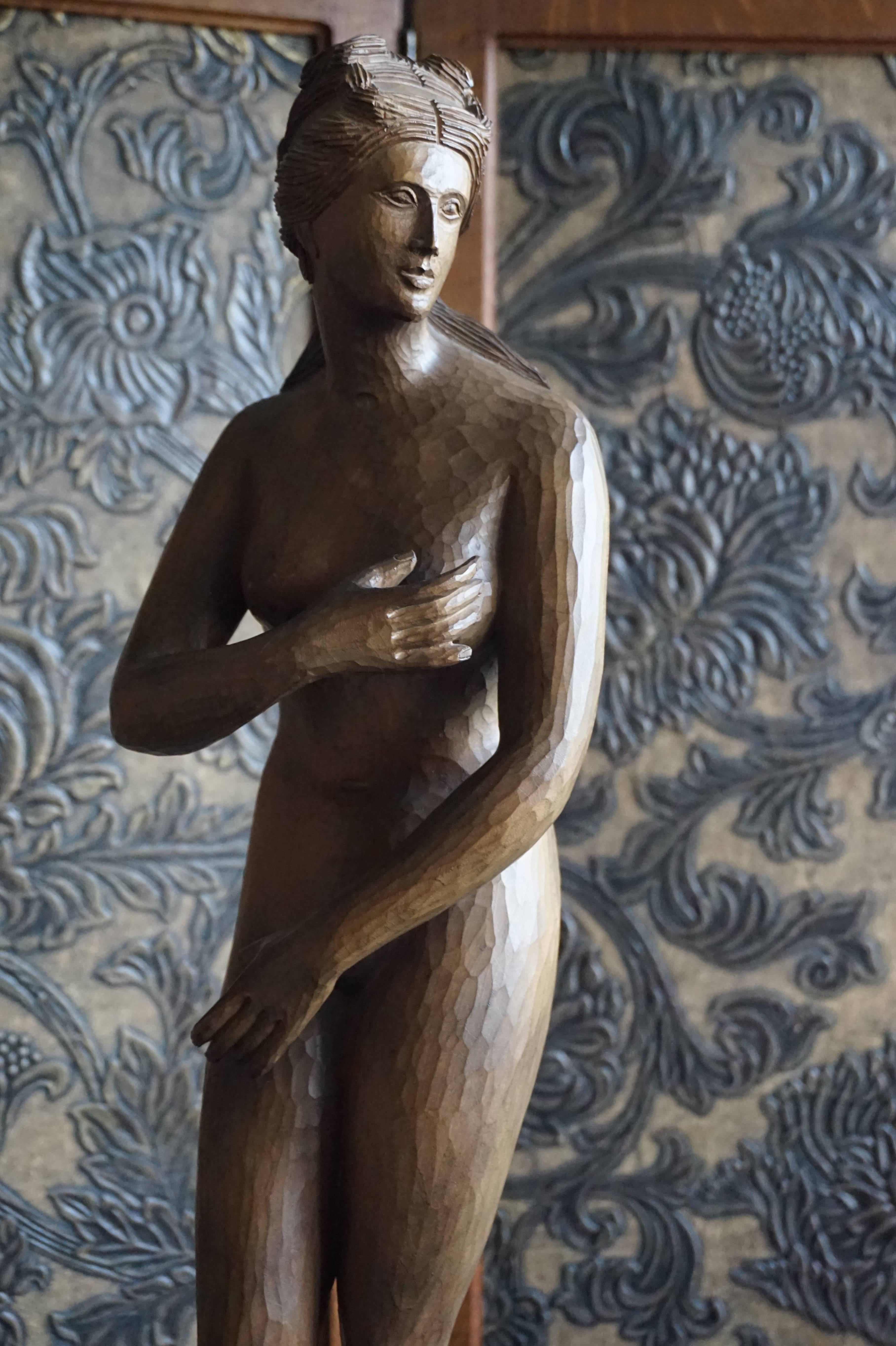 Stylish and decorative wooden female nude sculpture.

This relatively large sculpture is all hand-carved and in perfect condition. The special technique of carving, but not polishing the surface makes this classical nude look more ancient and