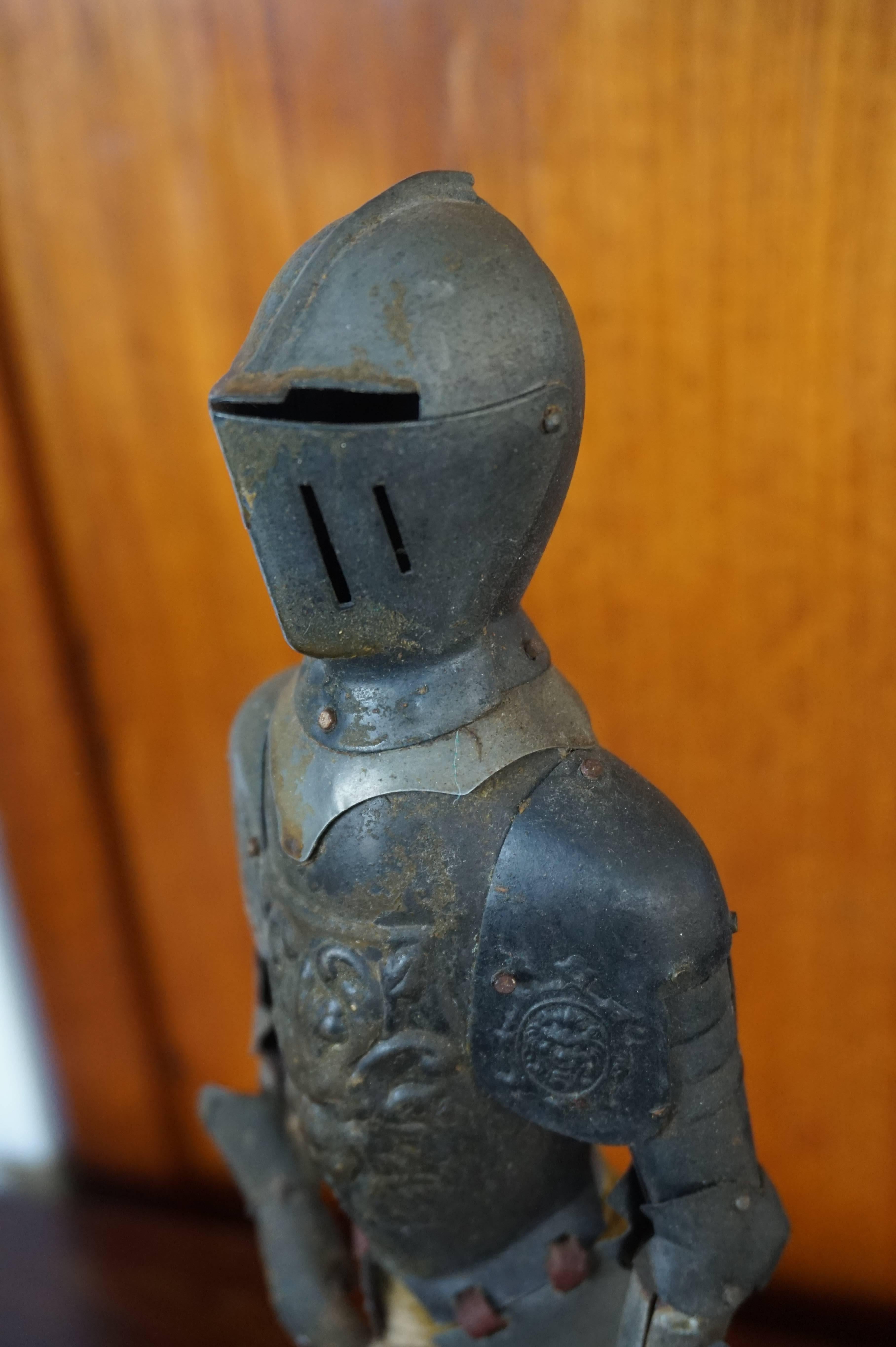 Unique miniature knight in not so shining armor.

This rare miniature of a standing knight in full armor dates from around 1910. It is mounted on a wooden and marble base and it is all handcrafted. The tin armor is nailed onto an wooden body and