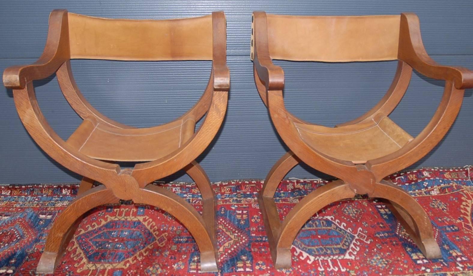 Stylish and hand made X-framed folding chairs from circa 1950.

These stylized Renaissance chairs are made of solid tiger oak and they come with leather seats and backs that are all in Fine condition. The combination of the smooth shape and