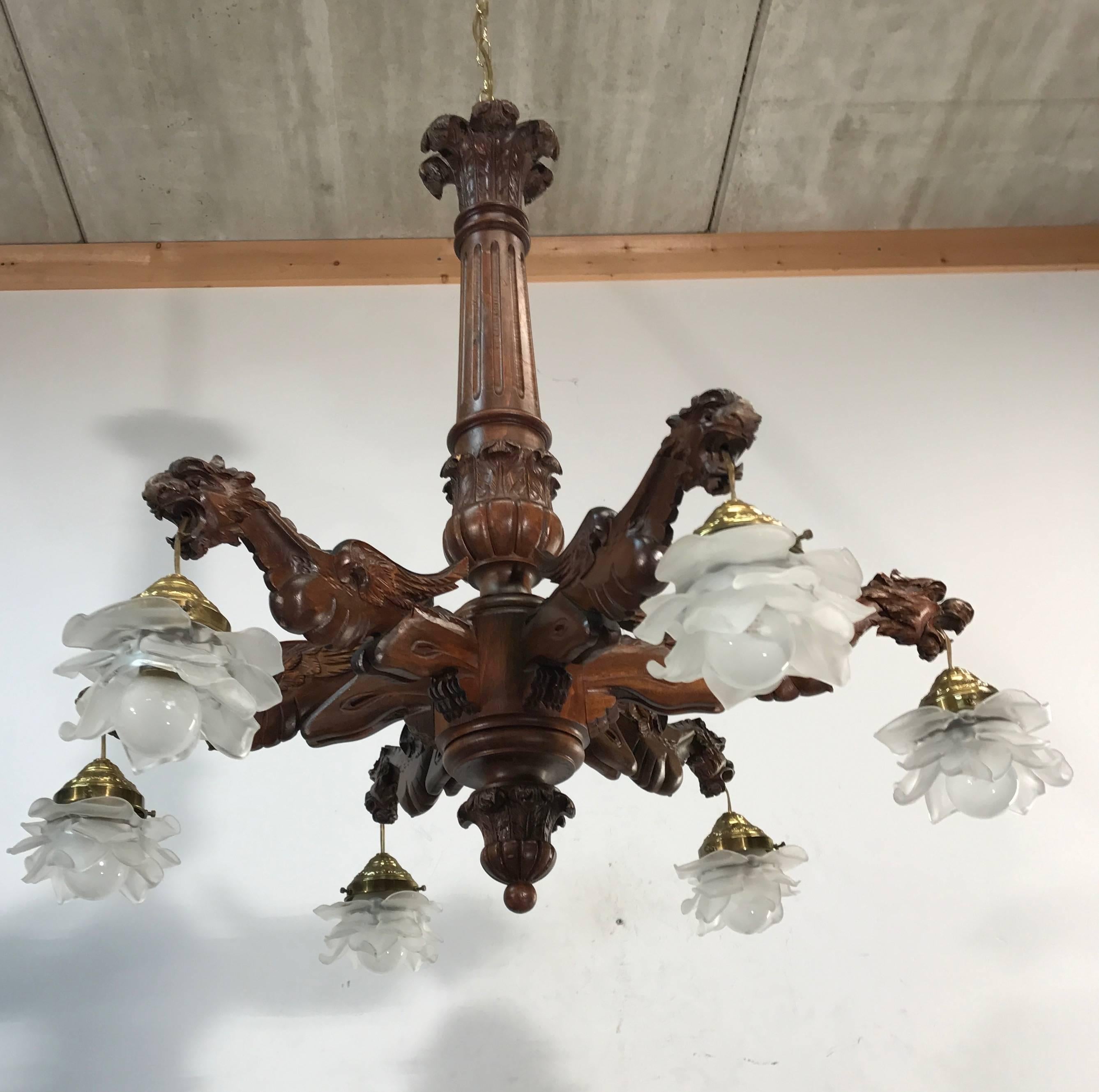 Good size and carved in beautiful detail.

This handcrafted chandelier comes with six arms and on the end of each arm there is a stunning and well carved dragon. They have a fierce expression and when you turn the light switch they will spit their