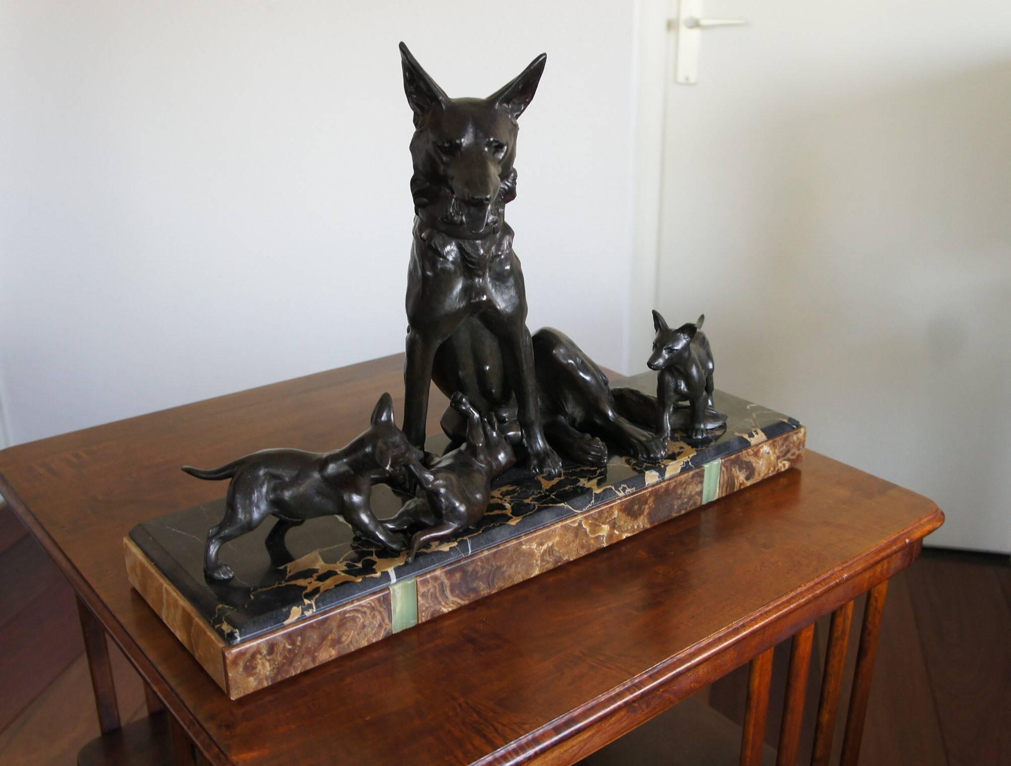 Wonderful sculpture of a dog family.

This mother of three looks patient and confident at the same time. It sure seems like it is a hot day, because she has her mouth open and her tongue is sticking out. Her offspring can lead a careless life and