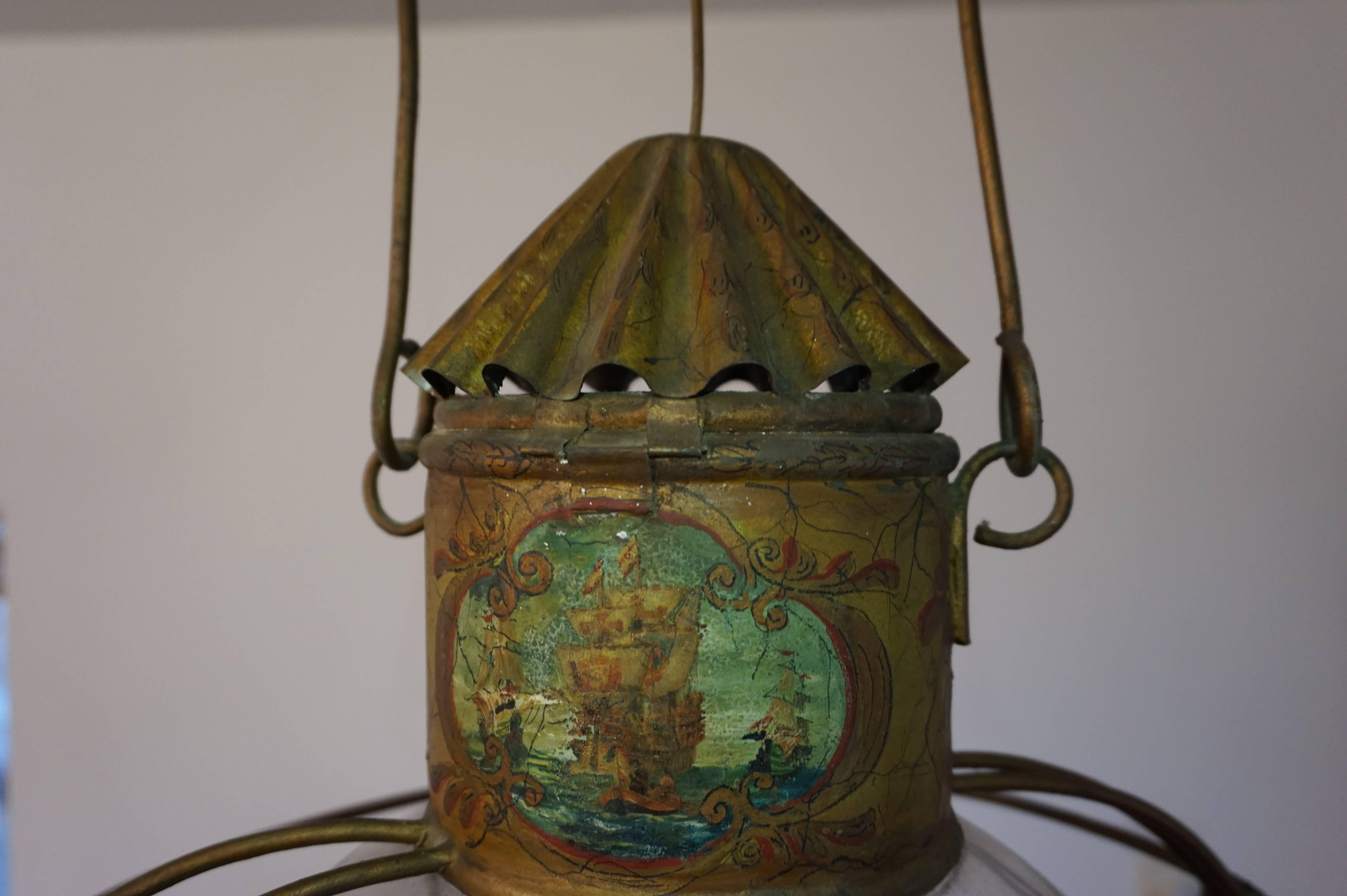 Rare ships lantern with original, hand-painted galleons at sea.

This rare and entirely hand crafted ships lantern is made electrical at some point in time, but originally it was made for candles (see image7). It still can be used as a candle