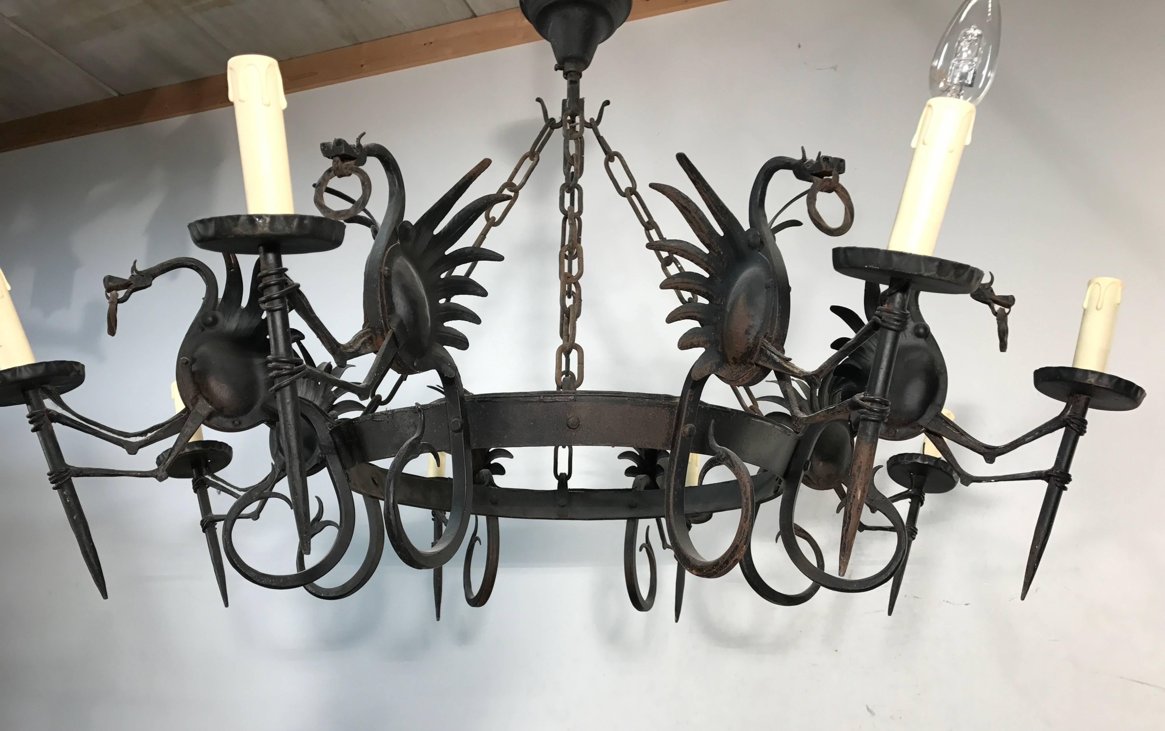 Amazing and skillfully made wrought iron pendant.

This artistically designed and very well executed wrought iron dragon chandelier is in excellent condition and it comes with stunning and mint dragons on all eight arms. If you are looking for a