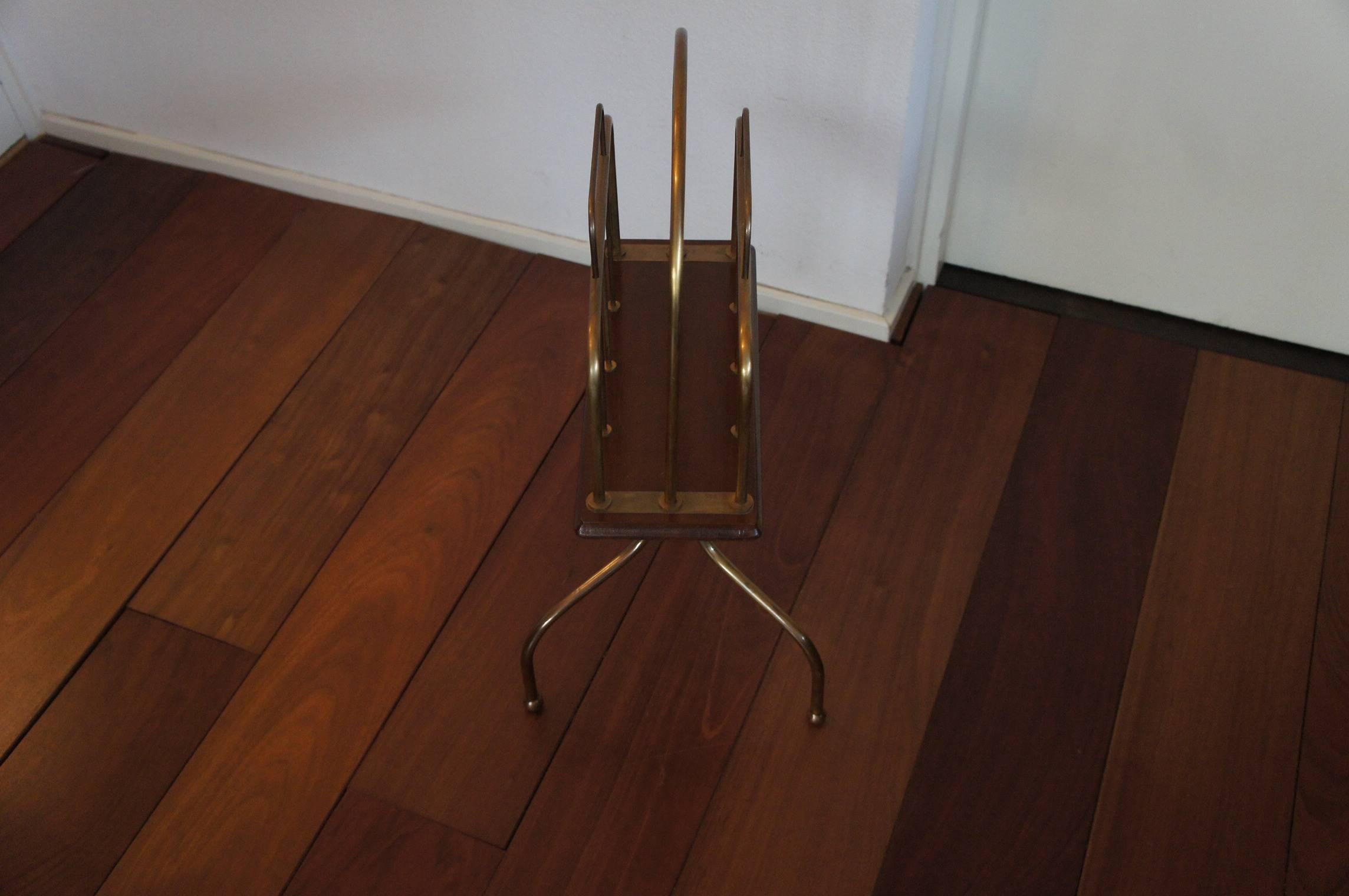 Practical and lovely design magazine stand.

If you like to keep your interior open and spacious than this handmade and highly practical magazine stand from the early 1900s will come in handy. This brass and wooden design rotates perfectly and
