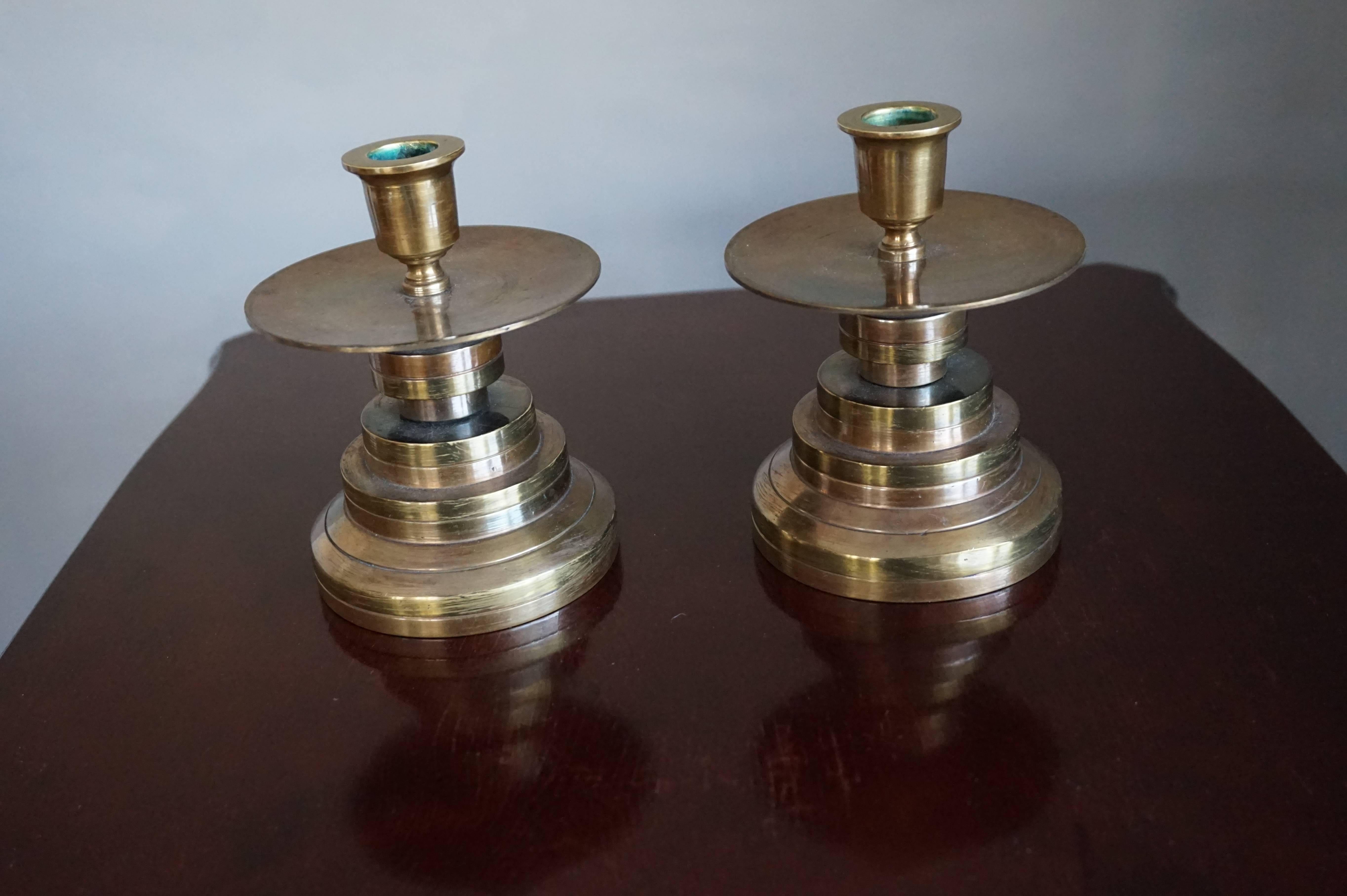 Beautiful and very stylish pair of timeless candle sticks.

From up close these stunning and heavy, brass candle sticks show scratches on the surface, but from a yard away no one will notice. Their Art Deco style and their great look and feel will