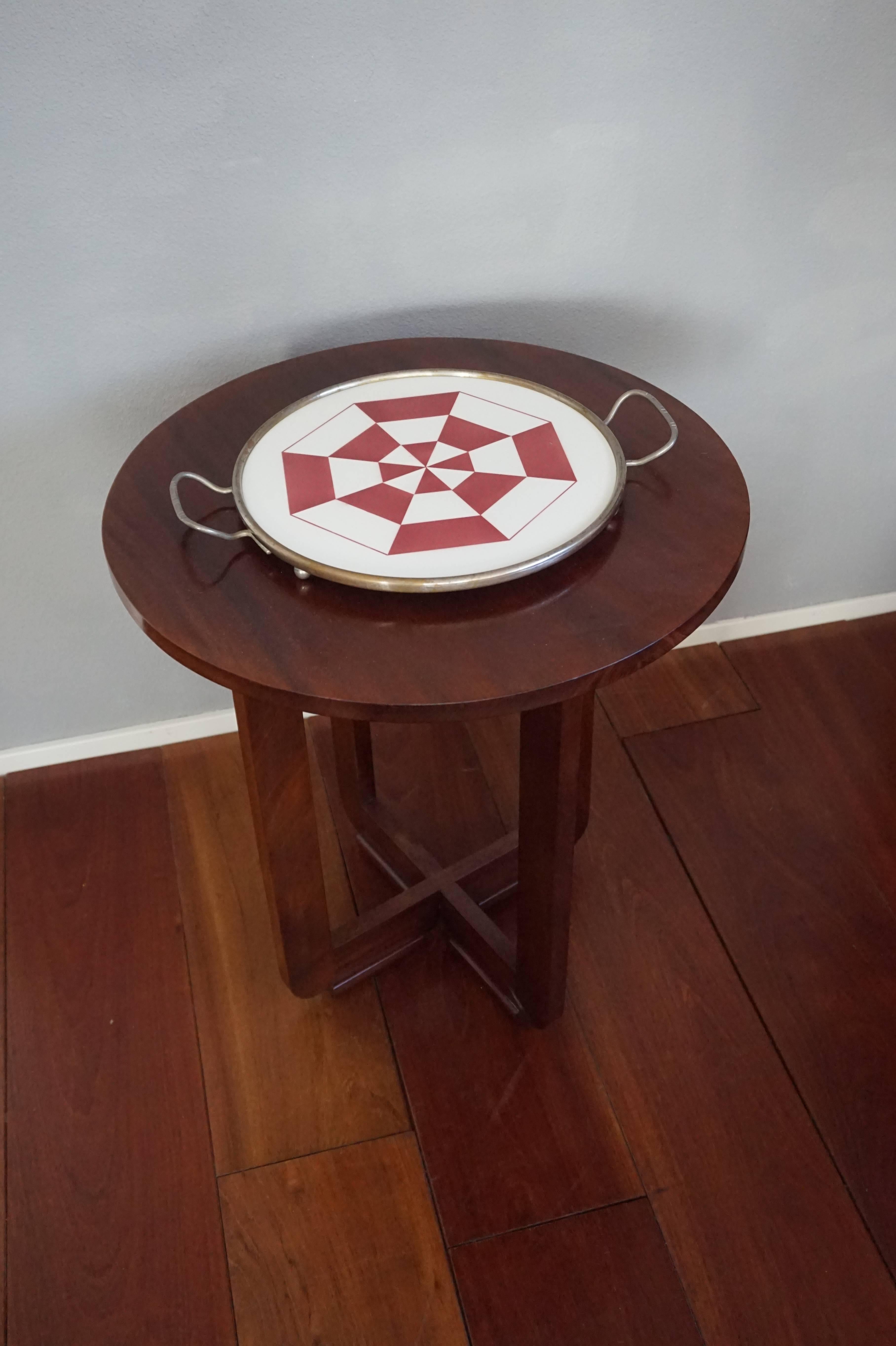 Beautiful and rare Art Deco tray.

This rare Art Deco serving tray with the beautiful, geometrical pattern is in excellent condition. It will look terrific atop a drinks cabinet, dresser, side table etc. This one piece, circular tile is in perfect