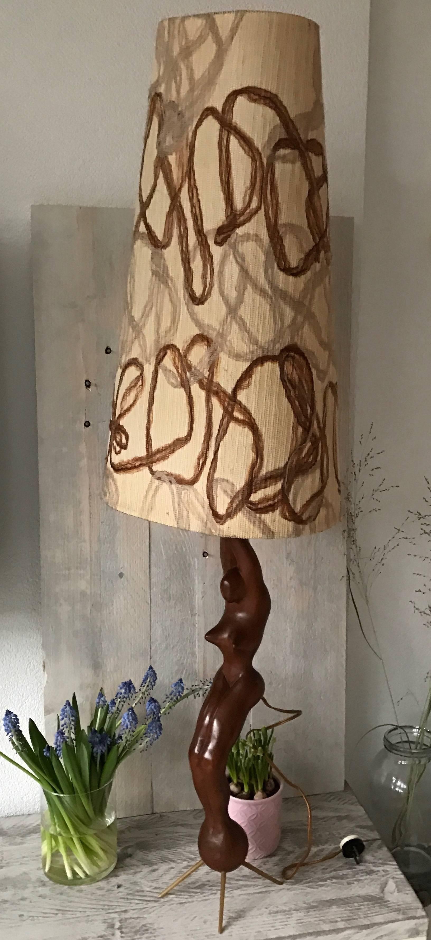 Beautifully shaped from top to bottom.

This hand-carved and stylish table or floor lamp is crafted out of one solid piece of teakwood. The natural grain in this beautiful hardwood accentuates the expressive and already exaggerated forms of this