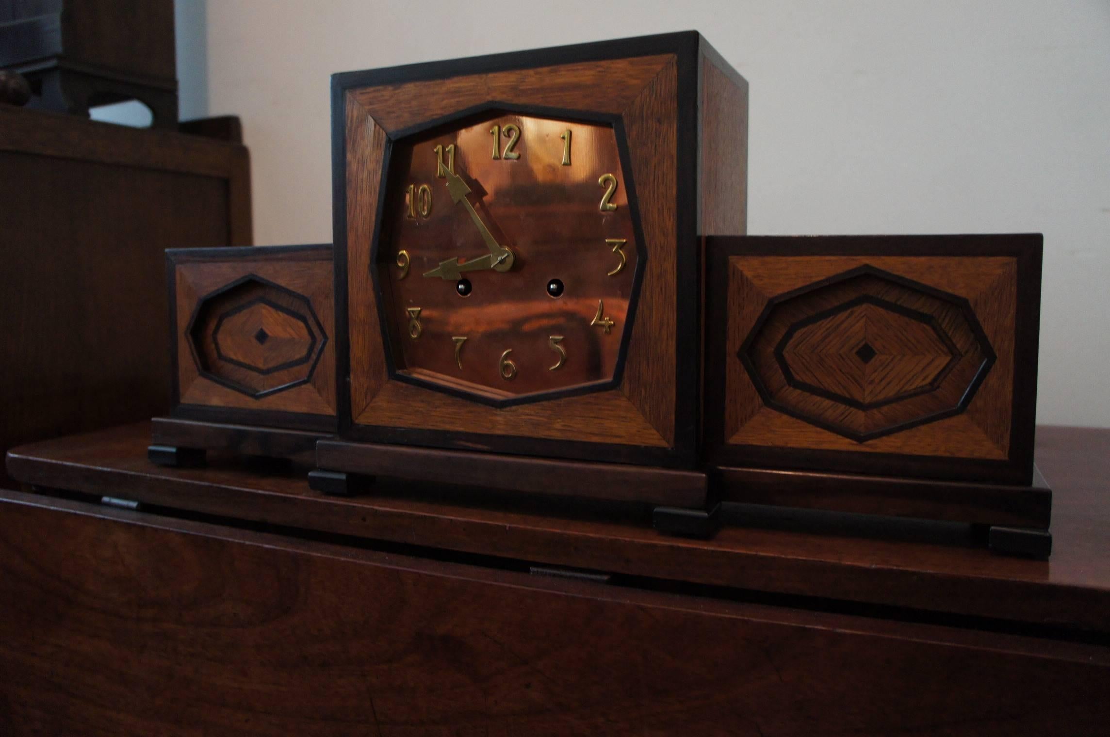 Handcrafted, geometrical design mantel clock.

This hand-crafted mantel clock from the 1920s is exceptional both in terms of design and execution. The many layers in the depth of the design are accentuated by the marquetry inlay of oak and macassar