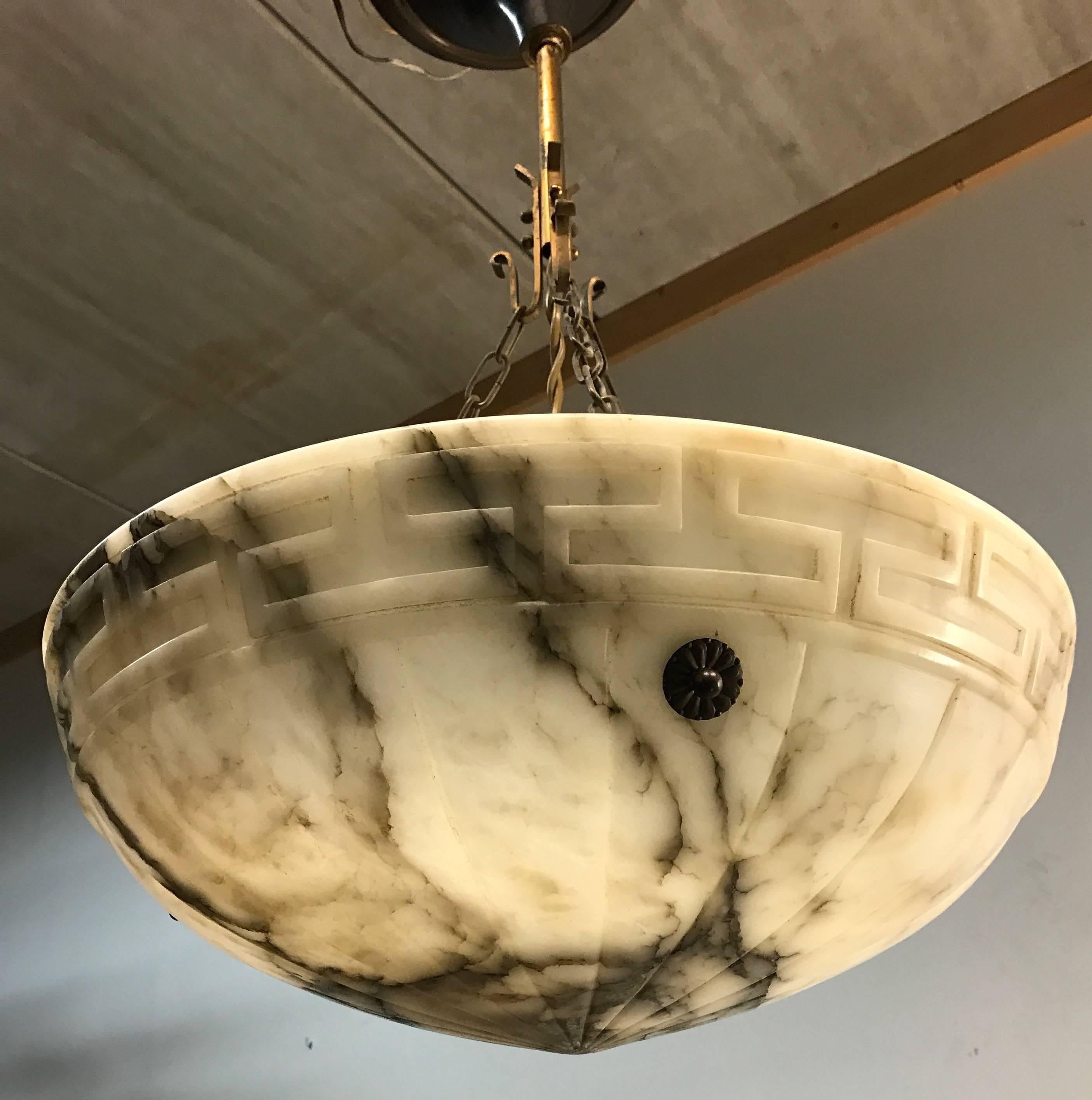 Good size, good quality and great value for money. 

This early 20th century alabaster pendant comes with brass chain and ceiling cap. The shape, the color and the effect of the veins in this beautiful natural mineral stone make this pendant a joy