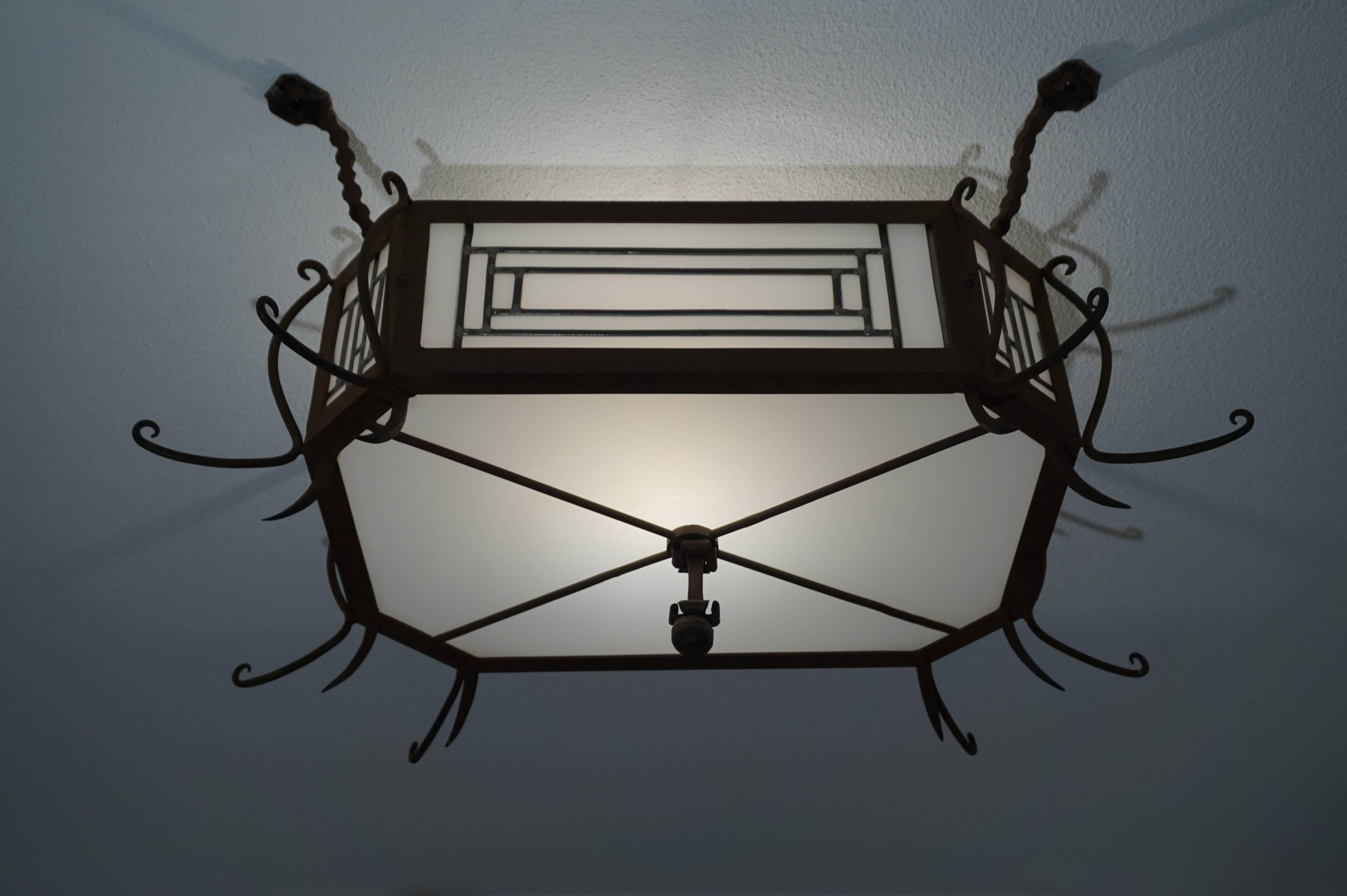 Unique and all handcrafted Art Deco flush mount.

Some antiques you only find once in your life and this is definitely the case with this hand-forged, early 20th century flush mount. This wrought iron and stained leaded glass fixture was made for a