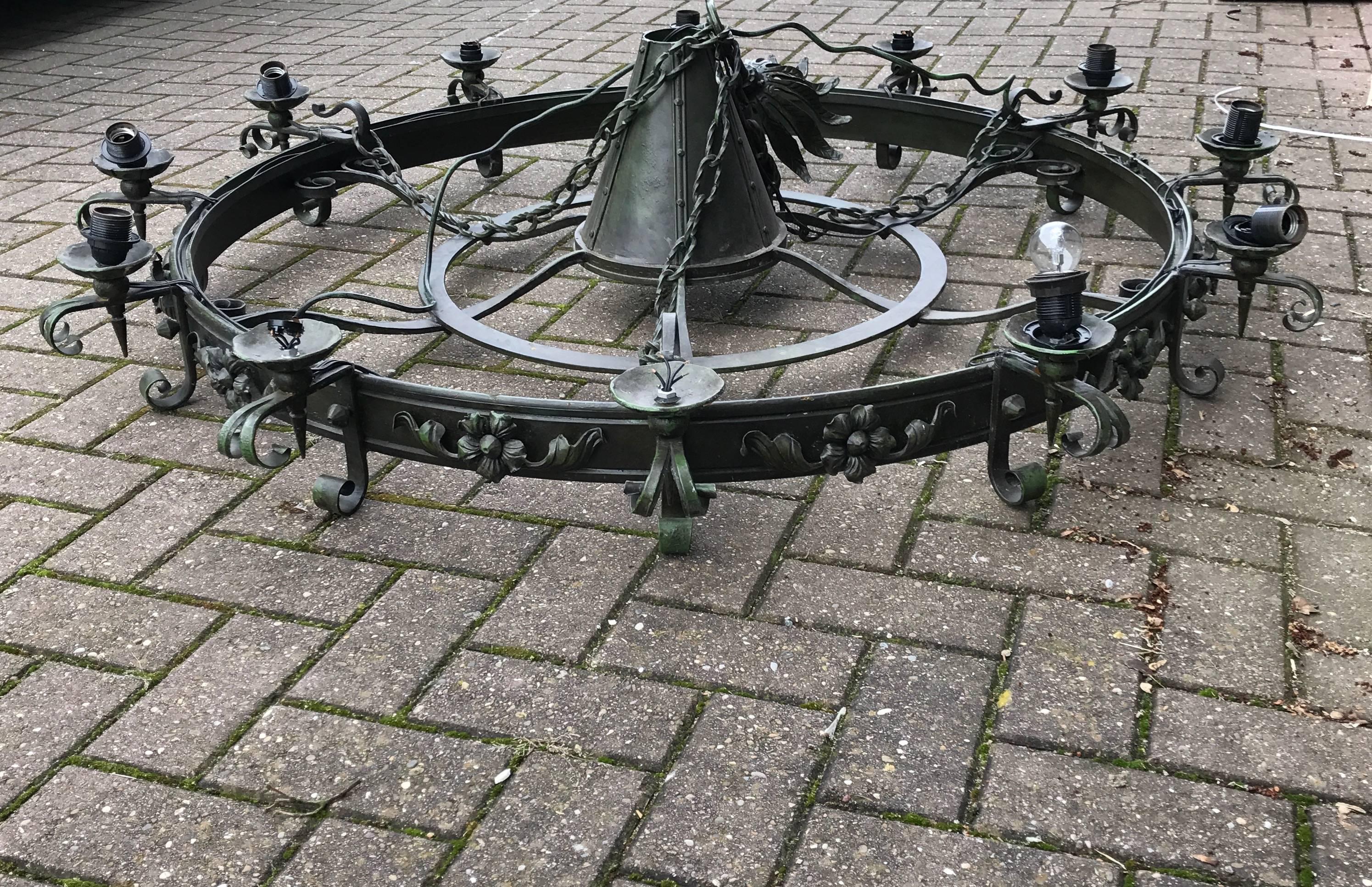 Good quality, impressive and handcrafted wrought iron chandelier. 

This enormous green and black, wrought iron chandelier is in excellent condition. The extra large shape makes it perfect for hanging in the centre of a large entrance, a restaurant,