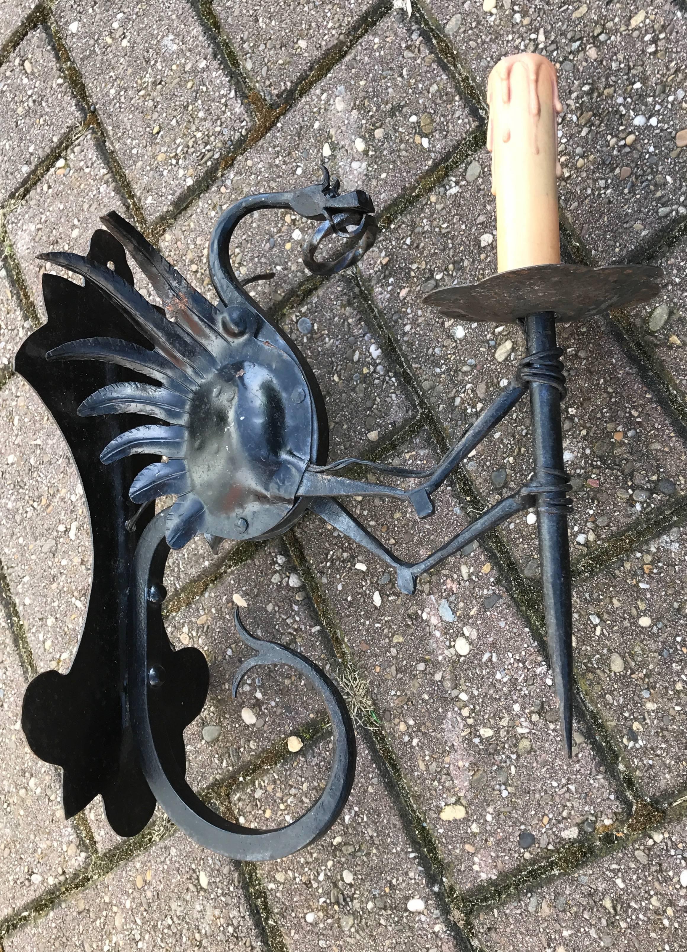 Amazing and skilfully made wrought iron sconce. 

This artistically designed and very well executed wrought iron dragon sconce is in excellent condition and it comes with a stunning and mint dragon sculpture. If you are looking for a statement piece