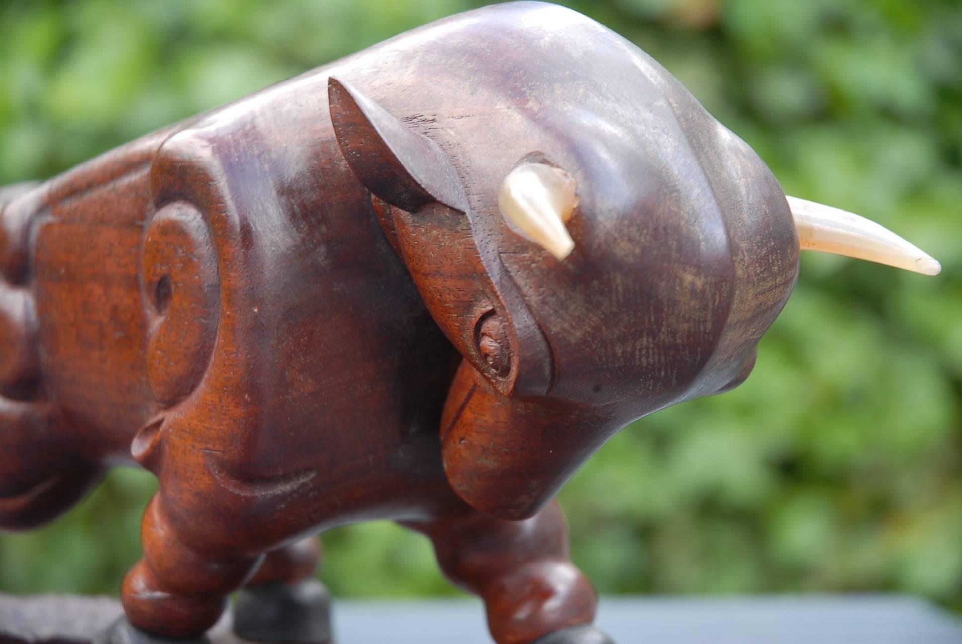 Amazing, sizeable and unique bull sculpture.

This unique sculpture of a charging bull is totally in a style of its own and it is in excellent condition. This truly is the work of an artisan with a capital A. The patina of this solid teakwood