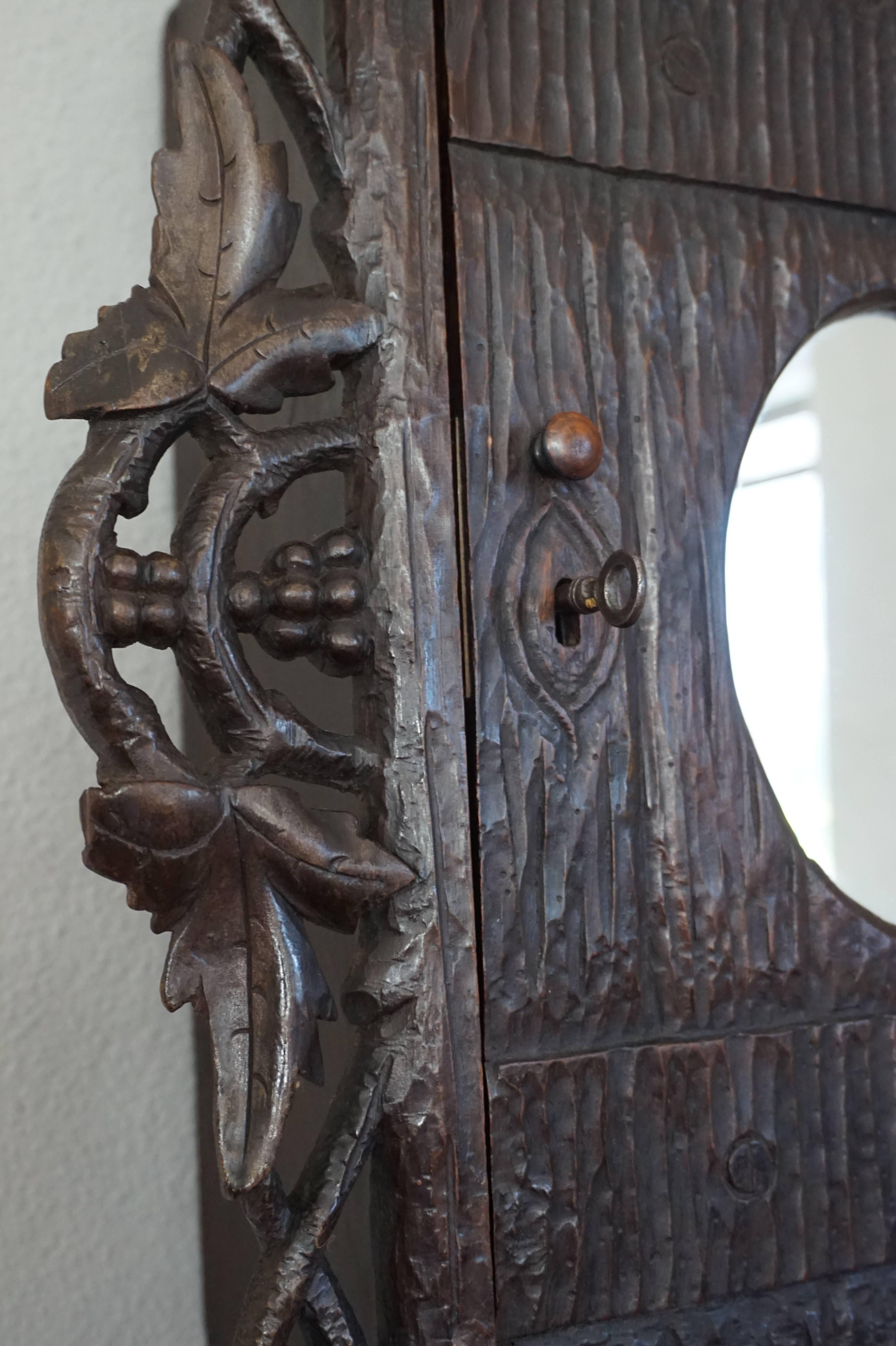 Antique and Hand-Carved Black Forest Medicine Wall Cabinet with Oval Mirror In Excellent Condition In Lisse, NL