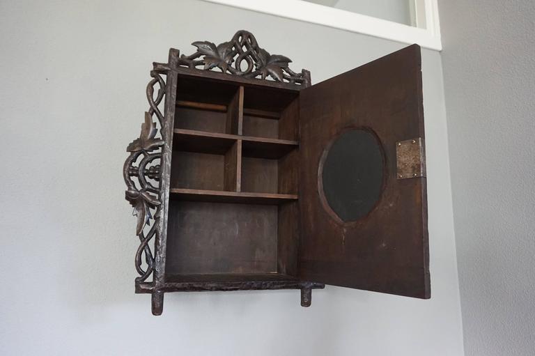 Antique and HandCarved Black Forest Medicine Wall with Oval