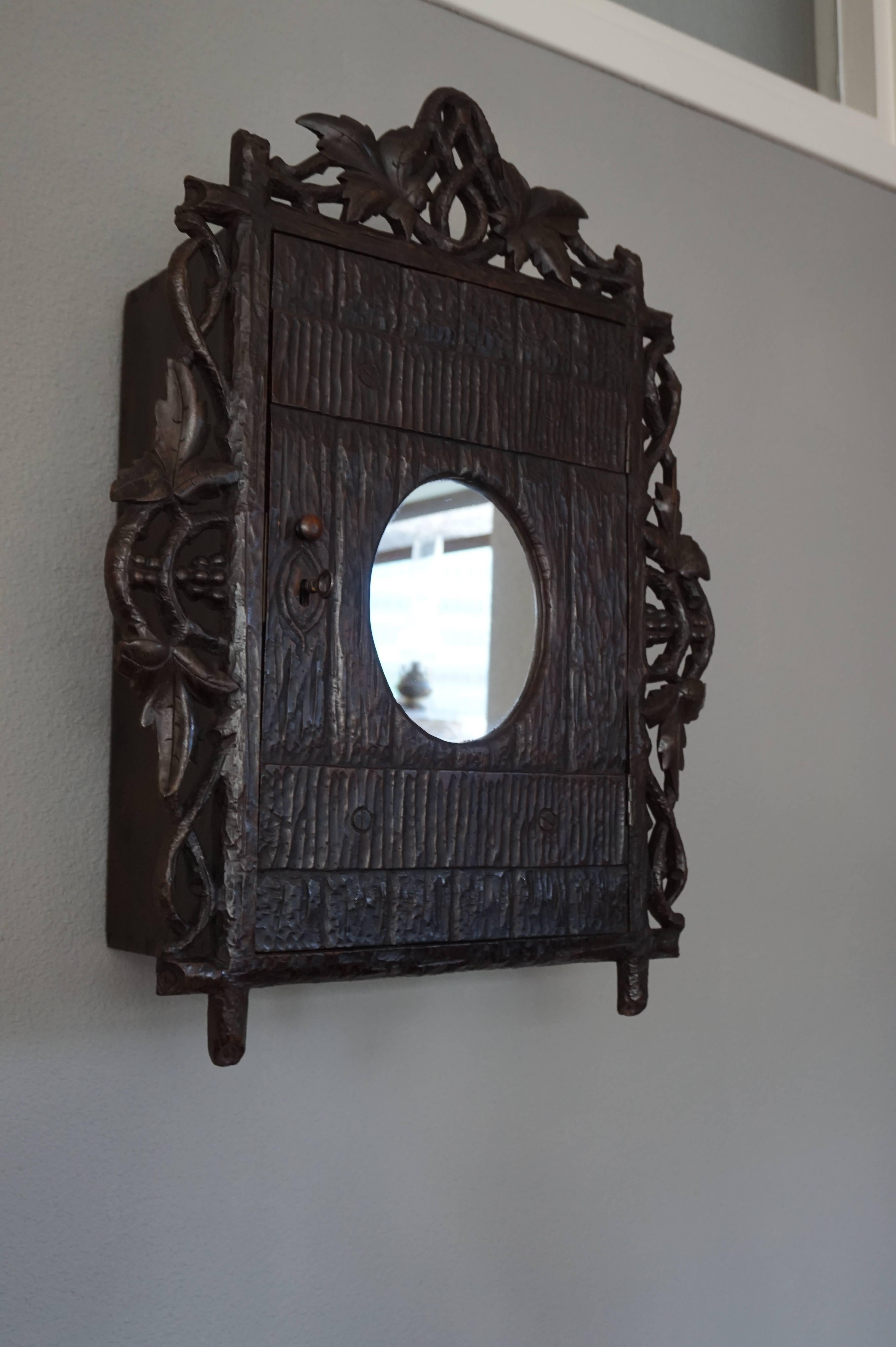 Antique and Hand-Carved Black Forest Medicine Wall Cabinet with Oval Mirror 4