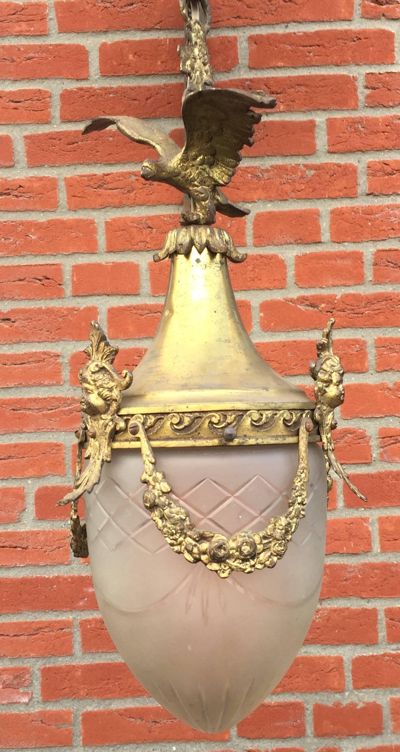 Vintage gold painted bronze and brass and hand engraved glass pendant.

If you are looking for a decorative pendant to light up your entrance, restroom or small bedroom than look no further. This French pendant with an eagle on top and guirlandes