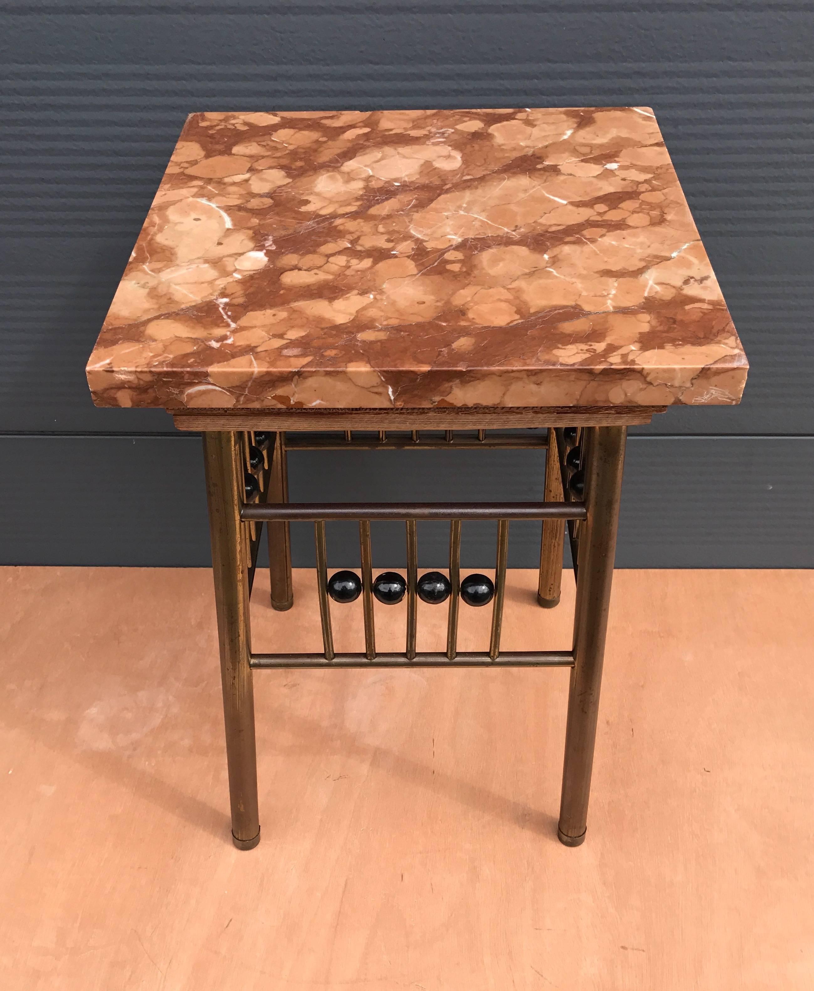 Modernist display stand from the turn of the century. 

This brass Viennese Secession plant stand is in the style of Koloman Moser and it is a beautiful and timeless design. The marble top was put on at a later date, but it goes very well with the