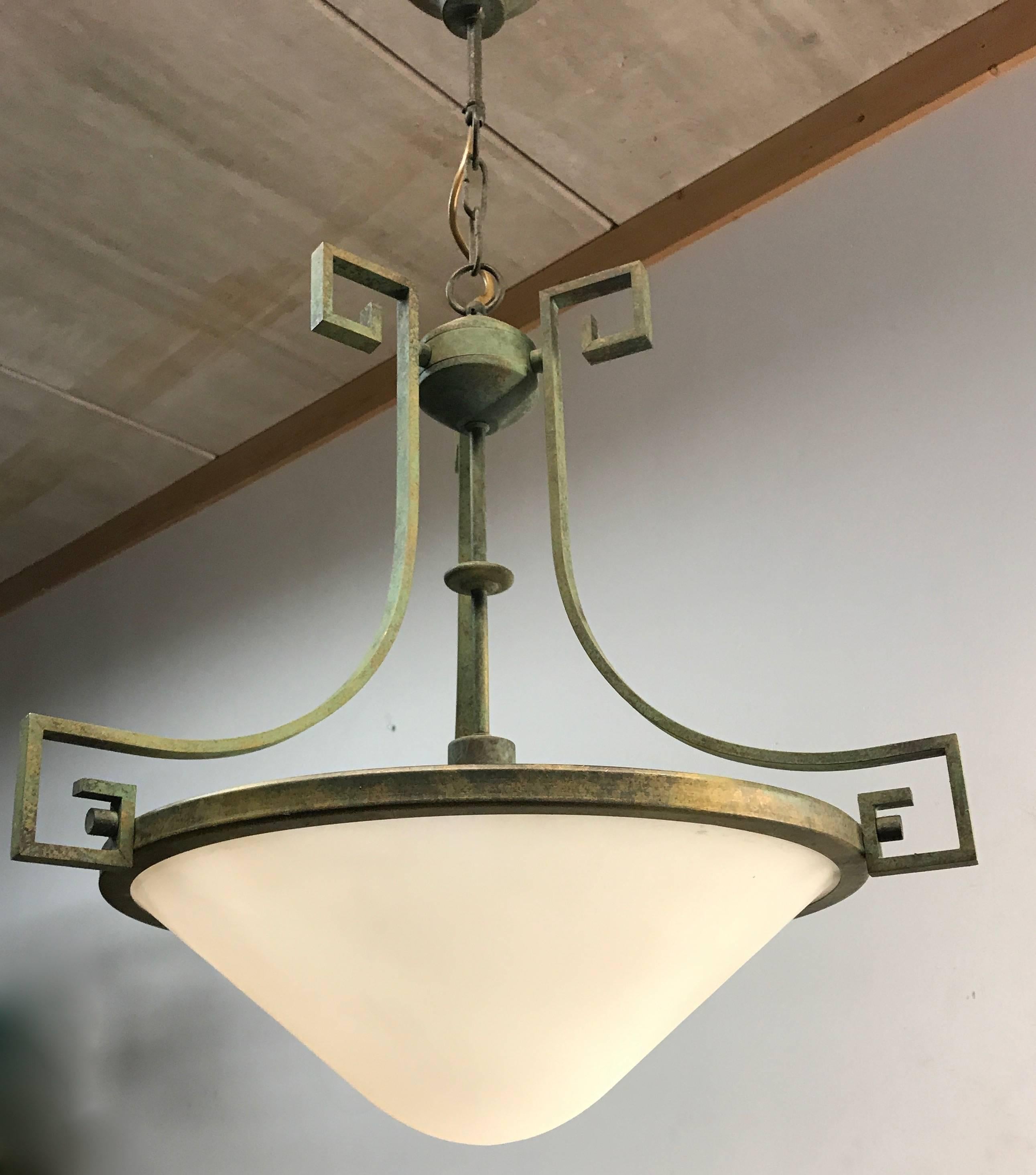 Great shape and color pendant.

This late 20th century, bronze patinated brass pendant comes with a matching brass chain and ceiling cap. All the brass is green bronze patinated which gives it its extra stylish and classical look and feel. The