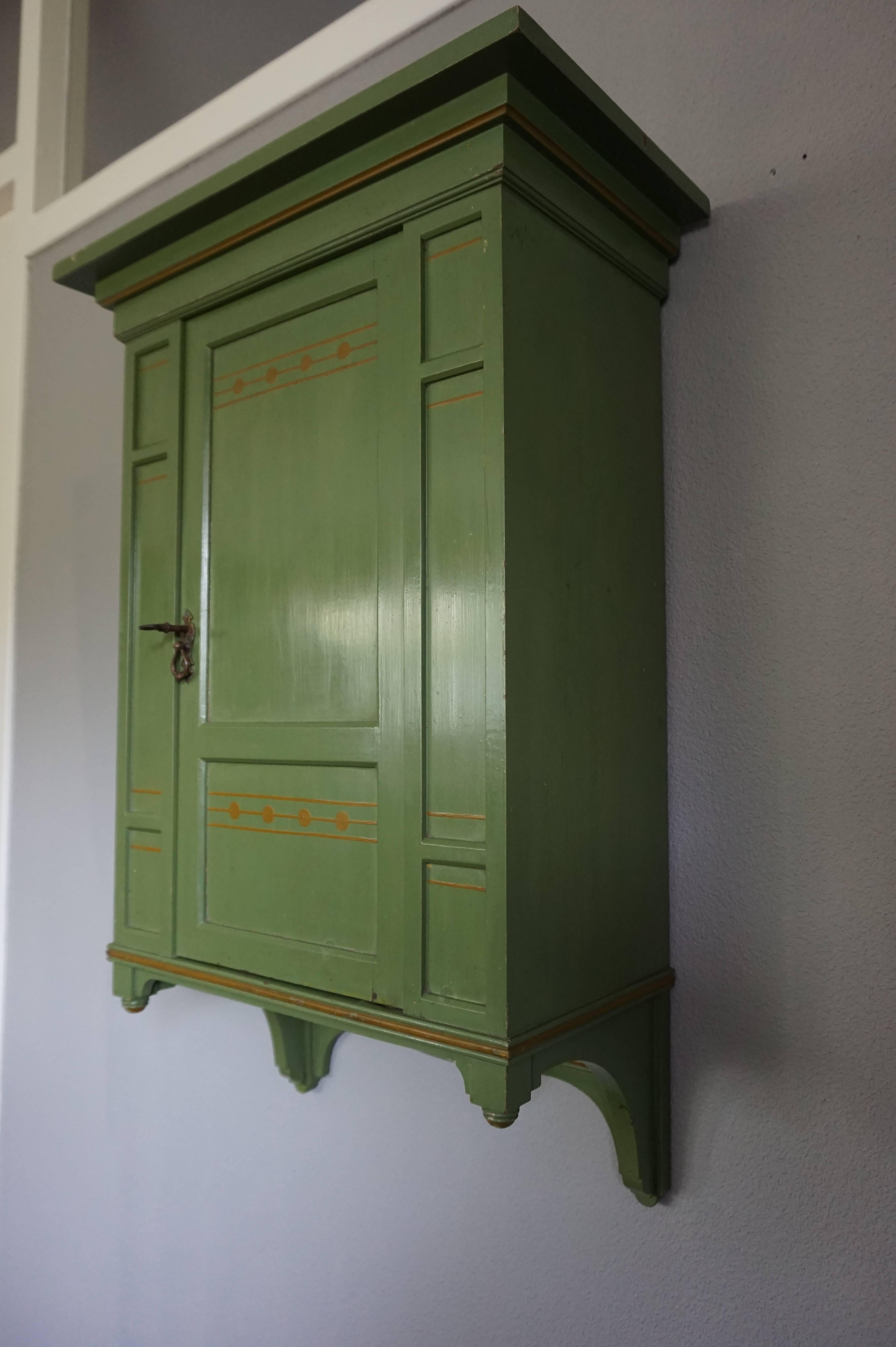 Handcrafted and hand-painted Dutch Jugendstil wall cabinet.

This very stylish and handcrafted wall cabinet from circa 1900 is by one of Hollands best en most renowned furniture makers. These pieces, with the 'Hollandia' mark on the back, in