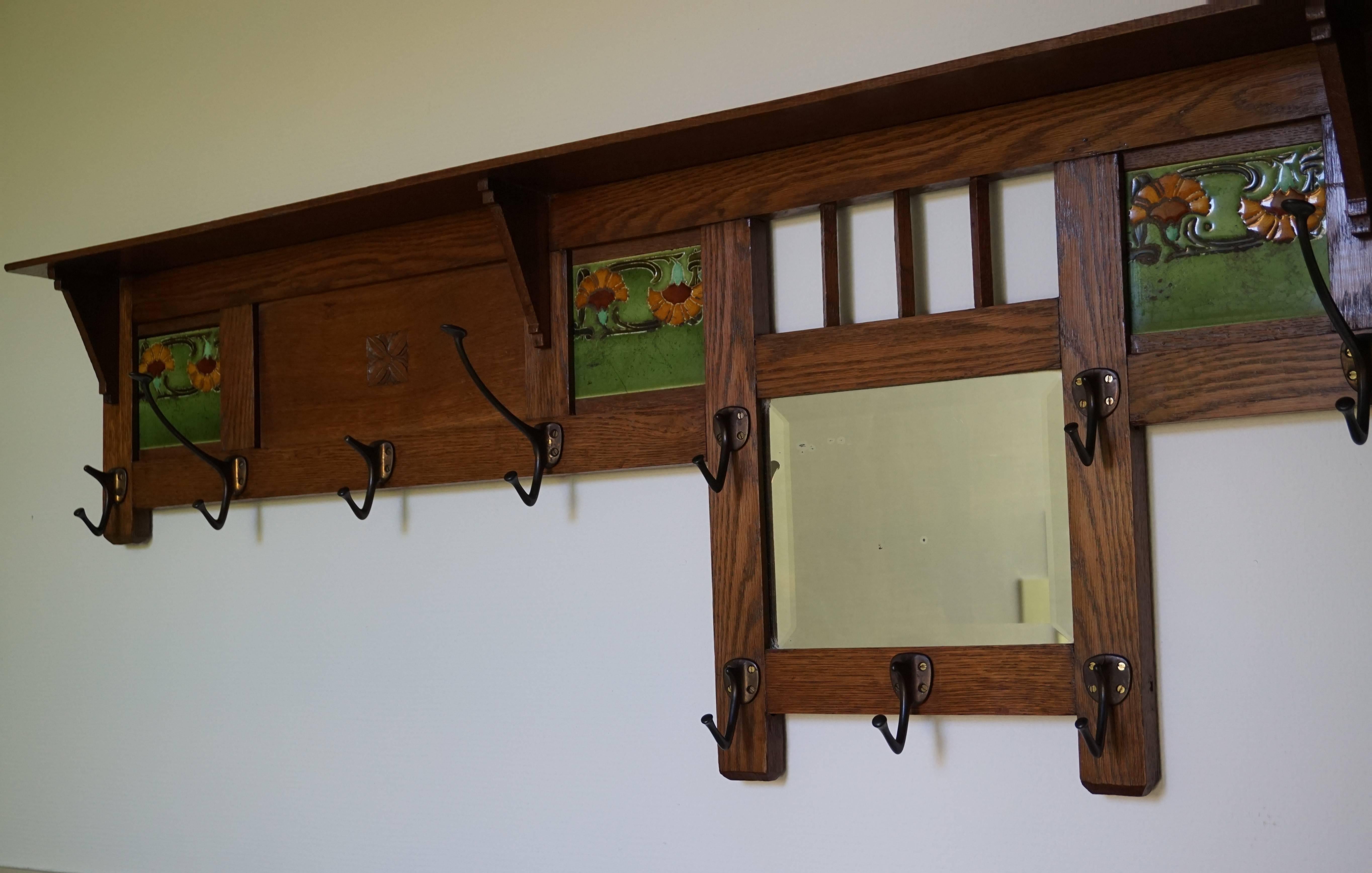 Long, beautiful and practical Arts and Crafts wall coat rack.

If you have the space and the ideal place for this impressive antique then you could not wish for a finer example. This handcrafted, oak with majolica tiles coat rack is both beautiful