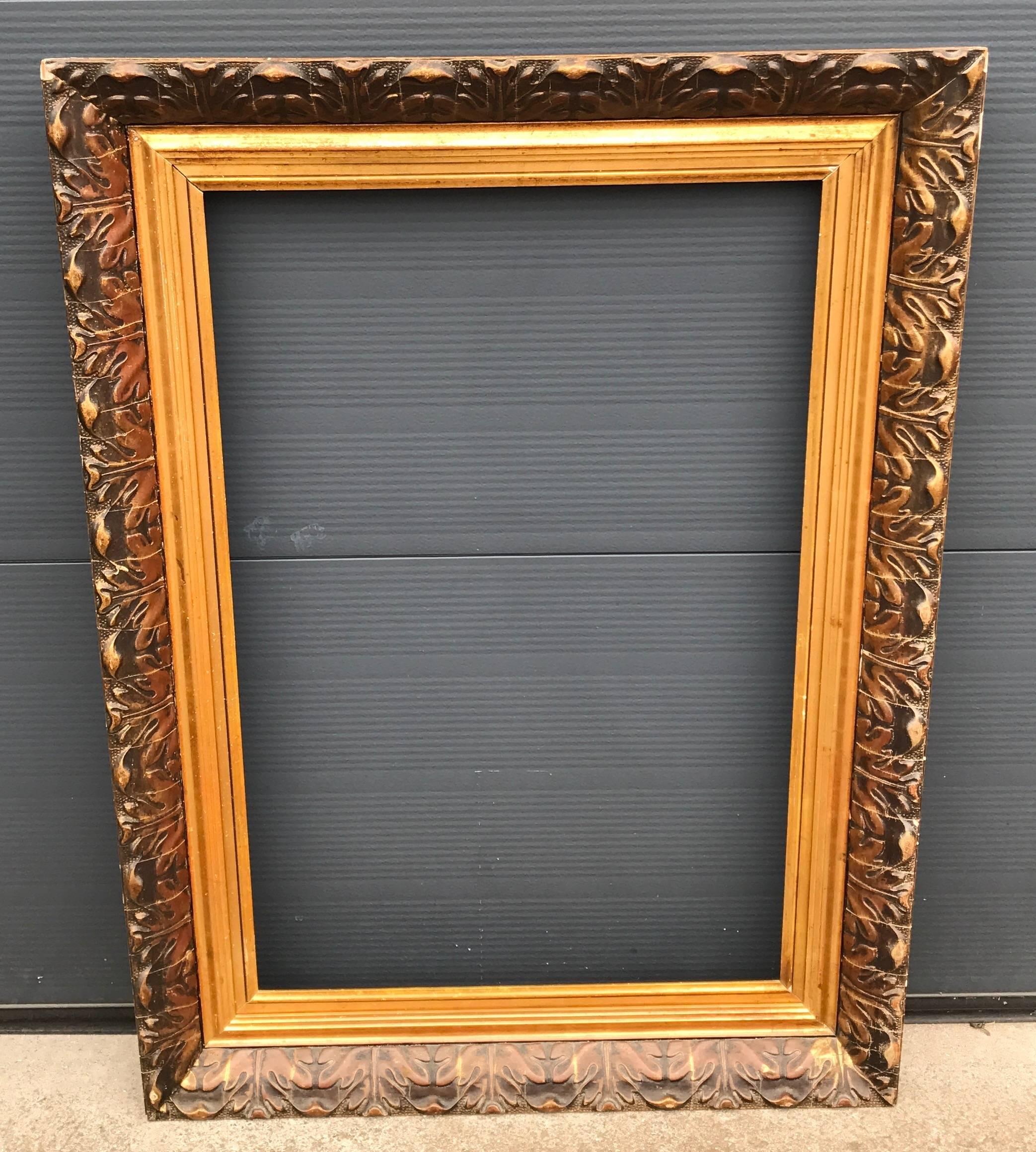 Good size and handcrafted frame for a mirror or painting.

This impressive size and shape frame is handcrafted around the turn of the century. The Arts and Crafts style leaf motifs are made from molded clay which are glued onto a wooden base.