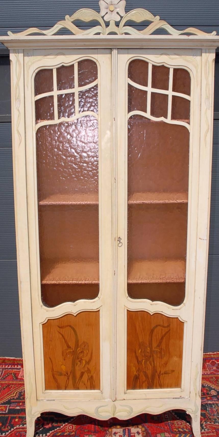 Elegant and slim, early 1900's Art Nouveau cabinet.

The multipurpose Art Nouveau cabinet is pearl colored and it comes with elegant carved and pastel color elements. Inside are four, adjustable in height shelves so -including the bottom- there are