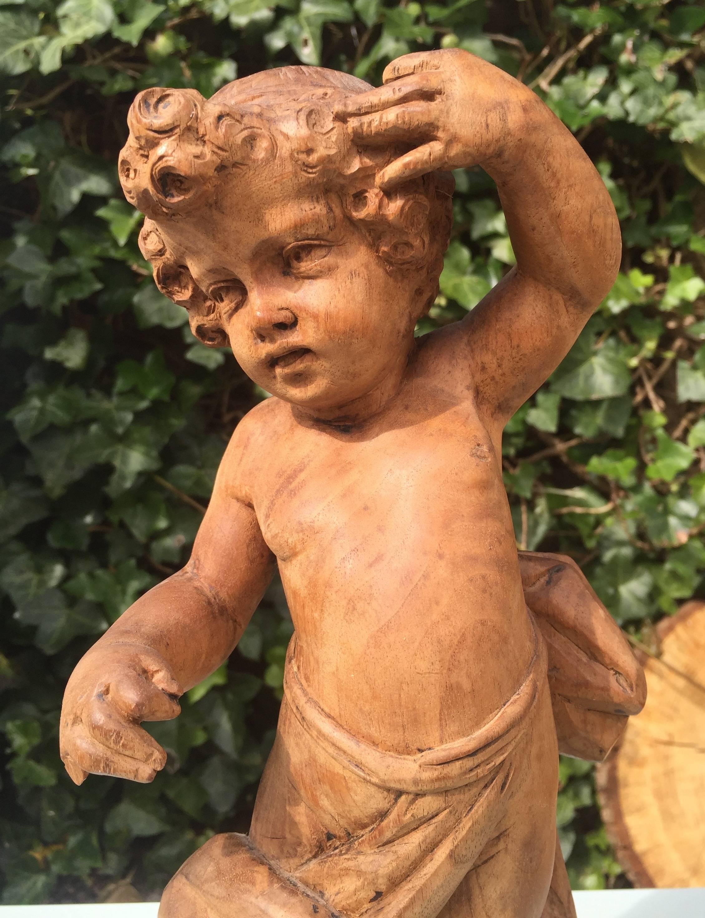 Lovely putto sculpture in typical Baroque Style.

This beautiful and chubby putto sculpture was probably part of a larger Church ornament/sculpture or it may have been attached to a beem somewhere high up (in image 6 you can see where it was once